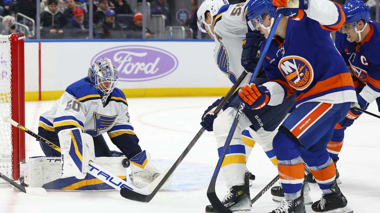 St. Louis Blues goaltender Jordan Binnington (50) makes a save against the New York Islanders during the second period of an NHL hockey game, Saturday, Nov. 23, 2024, in New York.