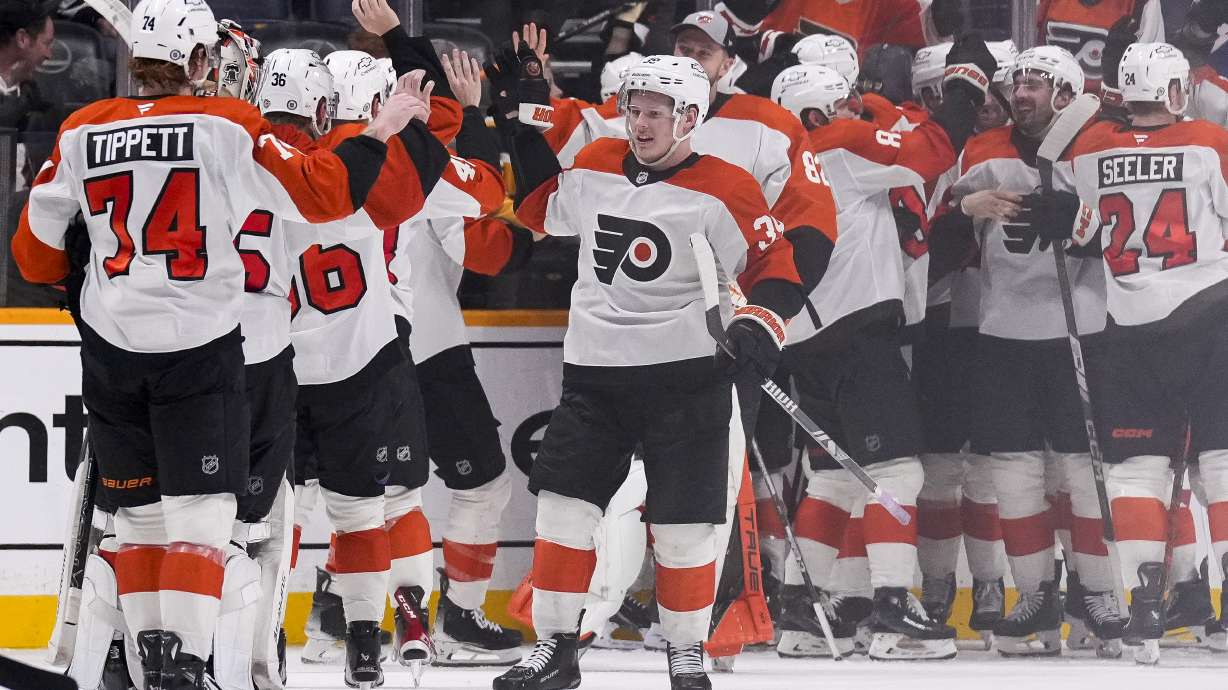 Philadelphia Flyers players celebrate the team's 3-2 overtime win against the Nashville Predators in an NHL hockey game Wednesday, Nov. 27, 2024, in Nashville, Tenn.