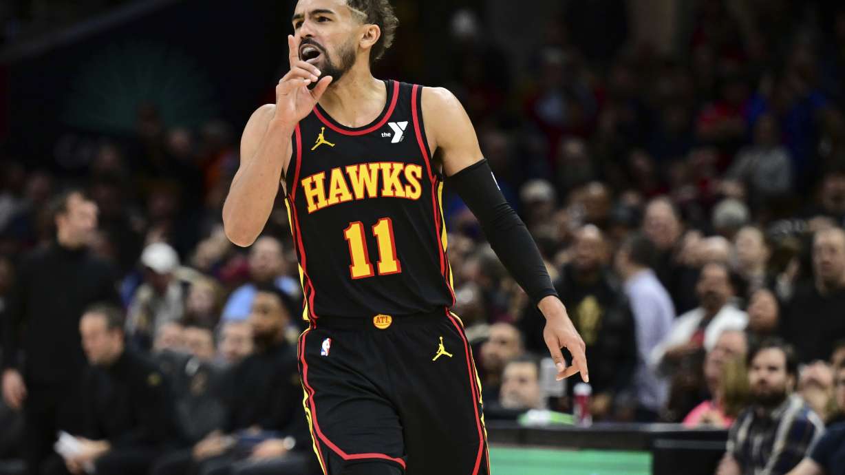 Atlanta Hawks guard Trae Young reacts after a three point basket in the second half of an NBA basketball game against the Cleveland Cavaliers, Wednesday, Nov. 27, 2024, in Cleveland.