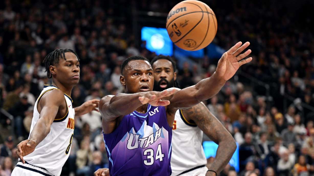 Utah Jazz center Oscar Tshiebwe (34) passes the ball out of the paint as the Jazz and the Nuggets play at the Delta Center in Salt Lake City on Wednesday, Nov. 27, 2024.