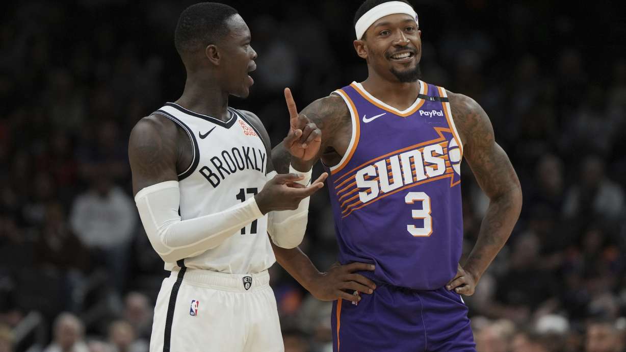 Brooklyn Nets guard Dennis Schroder and Phoenix Suns guard Bradley Beal (3) talk during the second half of an NBA basketball game, Wednesday, Nov. 27, 2024, in Phoenix. Brooklyn won 127-117.