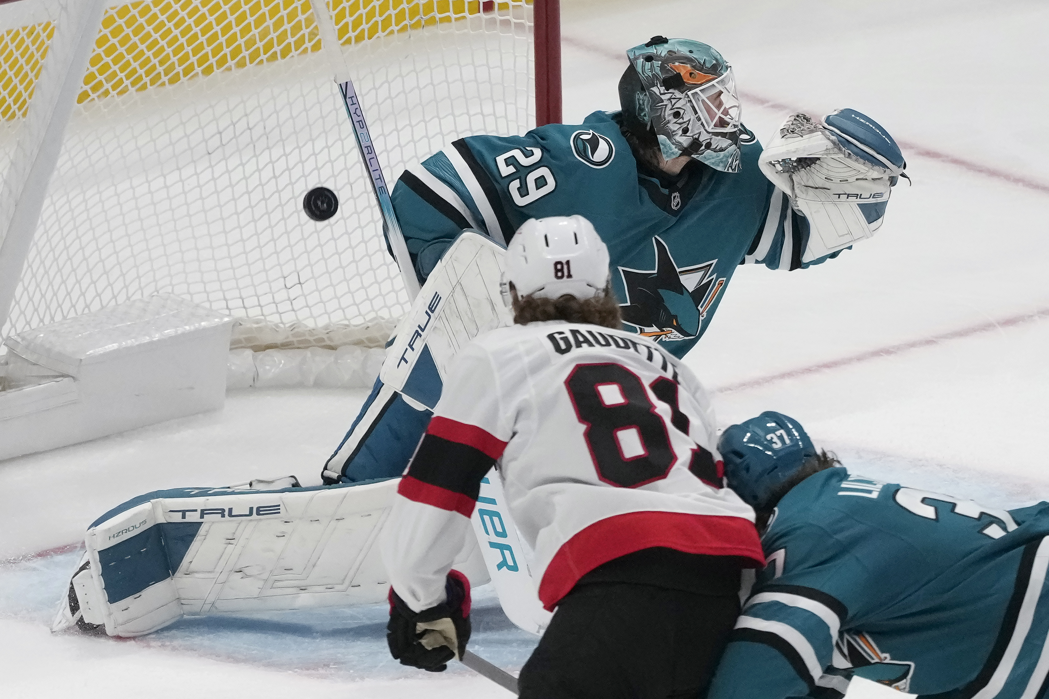 Ottawa Senators right wing Adam Gaudette, bottom left, scores a goal past San Jose Sharks goaltender Mackenzie Blackwood (29) during the third period of an NHL hockey game in San Jose, Calif., Wednesday, Nov. 27, 2024. 