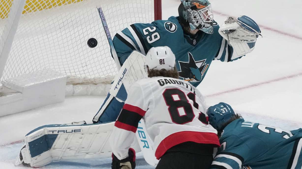 Ottawa Senators right wing Adam Gaudette, bottom left, scores a goal past San Jose Sharks goaltender Mackenzie Blackwood (29) during the third period of an NHL hockey game in San Jose, Calif., Wednesday, Nov. 27, 2024.