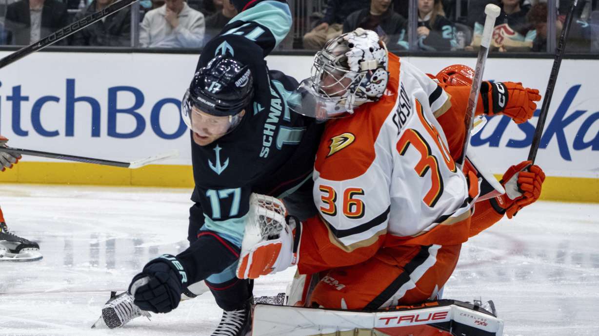 Seattle Kraken forward Jaden Schwartz, left, collides with Anaheim Ducks goalie John Gibson during the second period of an NHL hockey game, Wednesday, Nov. 27, 2024, in Seattle.