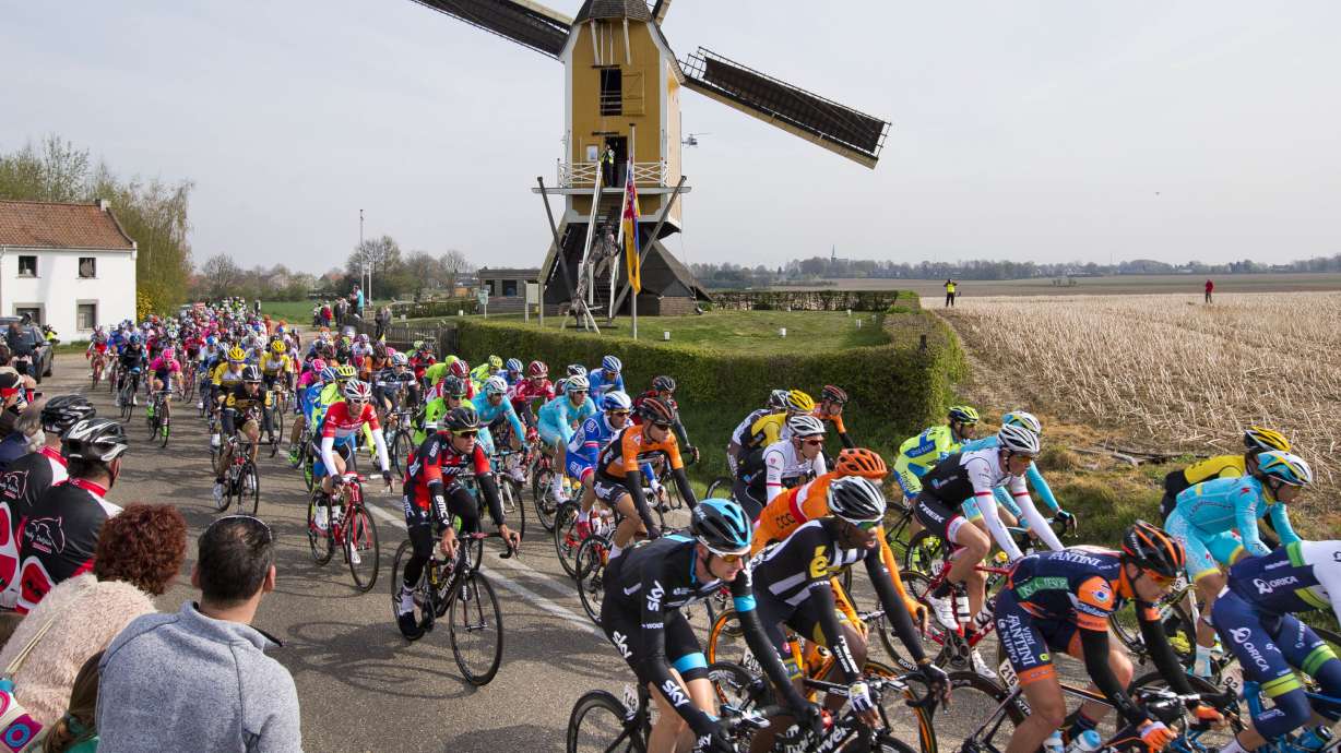 FILE - The pack passes a windmill near the village of Beek during the 50th edition of the Amstel Gold cycling race over 258 kilometers (160 miles) with start in Maastricht and finish in Valkenburg, southern Netherlands, Sunday, April 19, 2015.