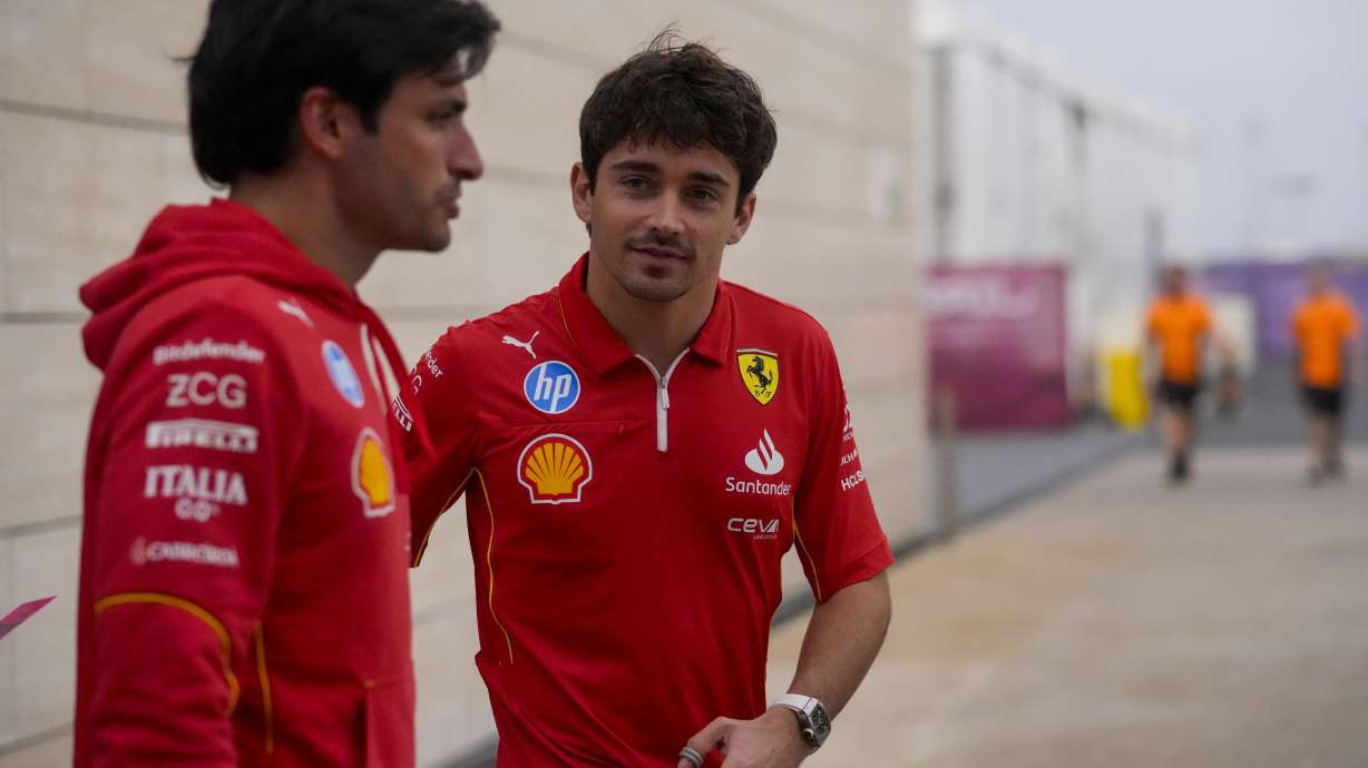 Ferrari driver Carlos Sainz of Spain, left, and Ferrari driver Charles Leclerc of Monaco walk through paddock at the Lusail International Circuit in Lusail, Qatar, ahead of the Qatar Grand Prix, Thursday, Nov. 28, 2024.