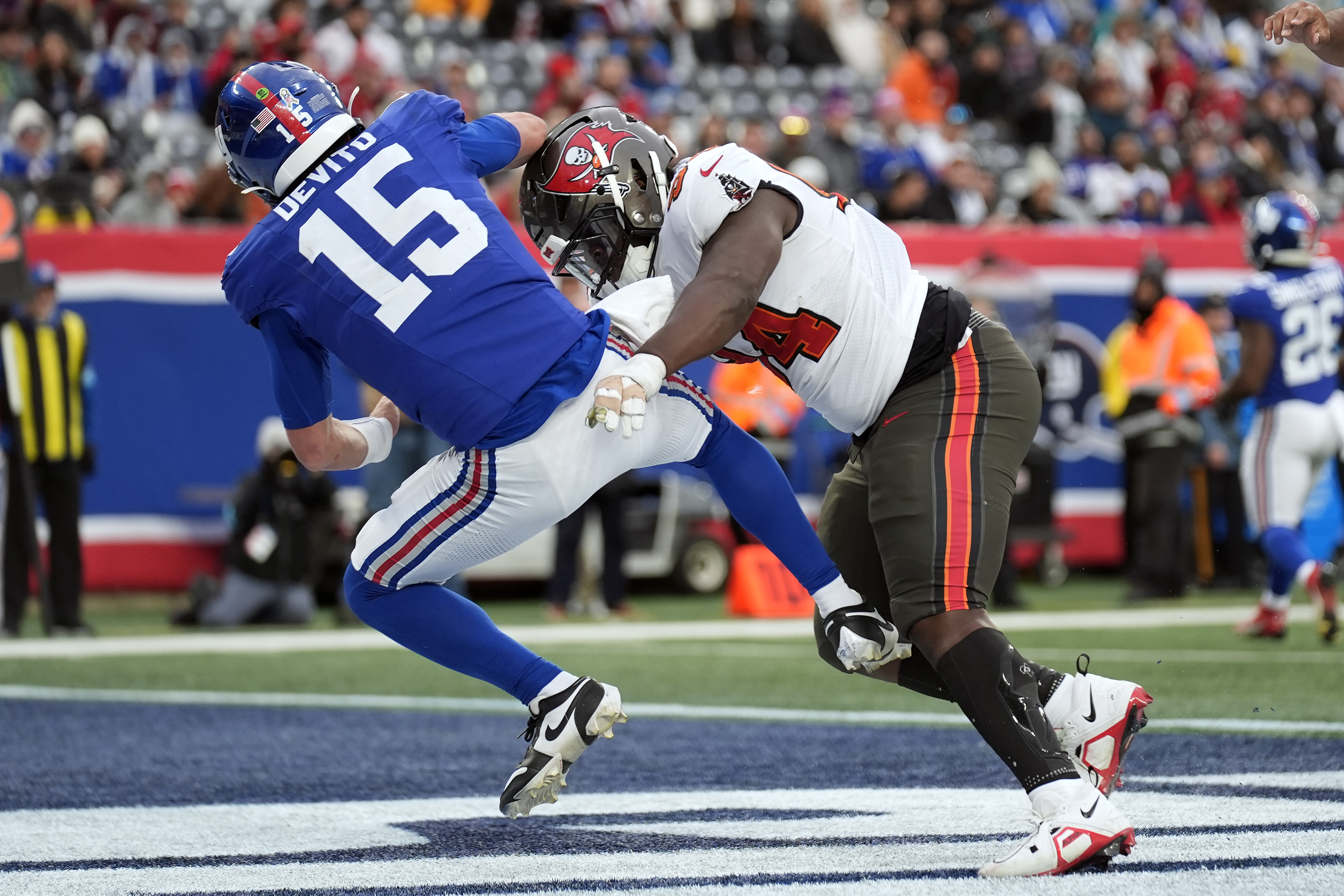 Tampa Bay Buccaneers defensive tackle Calijah Kancey (94) hits New York Giants quarterback Tommy DeVito (15) after a pass during the second half of an NFL football game Sunday, Nov. 24, 2024, in East Rutherford, N.J. 