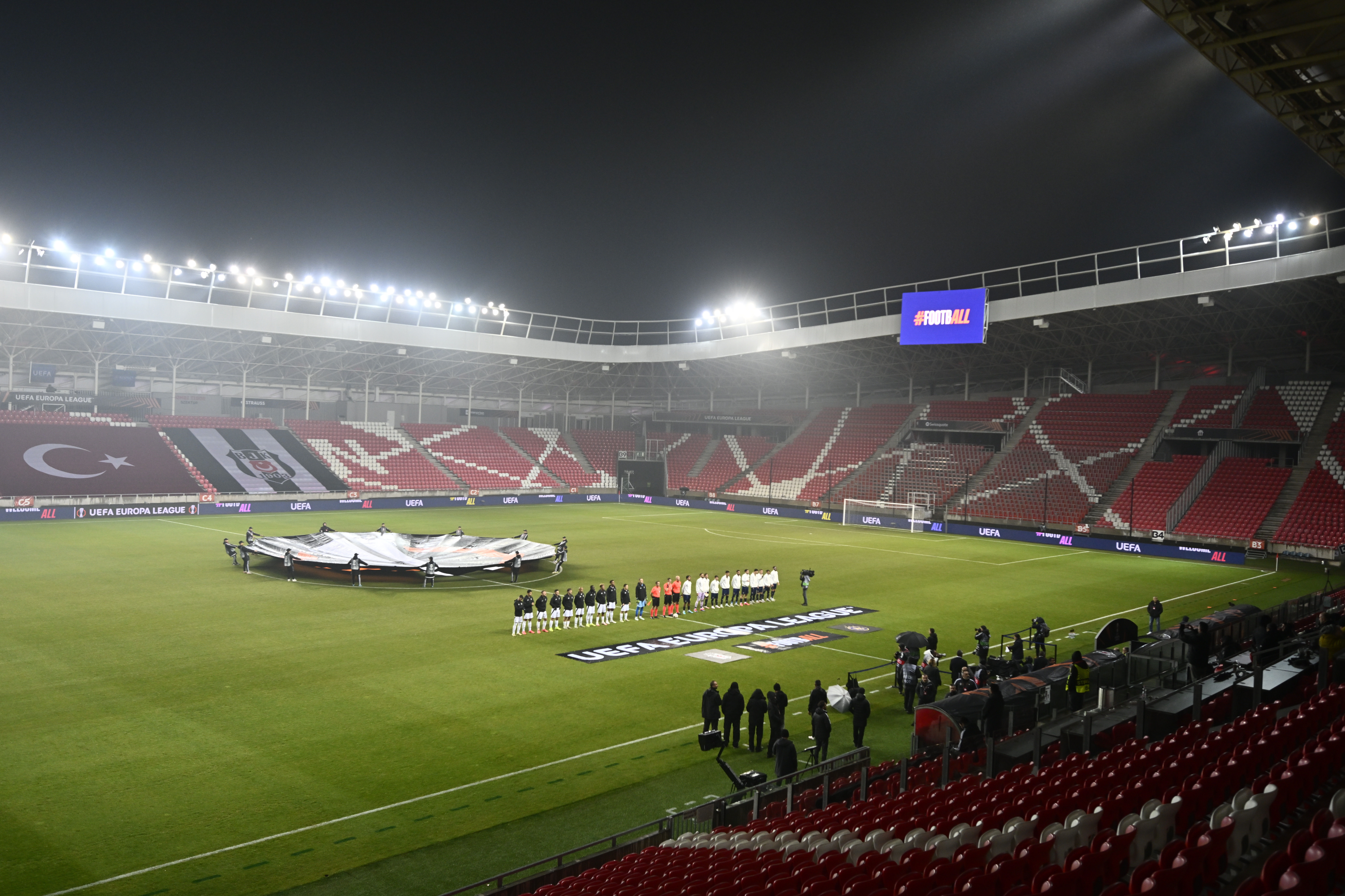 Players line up prior to the kick-off of the Europa League opening phase soccer match between Besiktas and Maccabi Tel Aviv, at the Nagyerdei Stadium in Debrecen, Hungary, Thursday, Nov. 28, 2024.