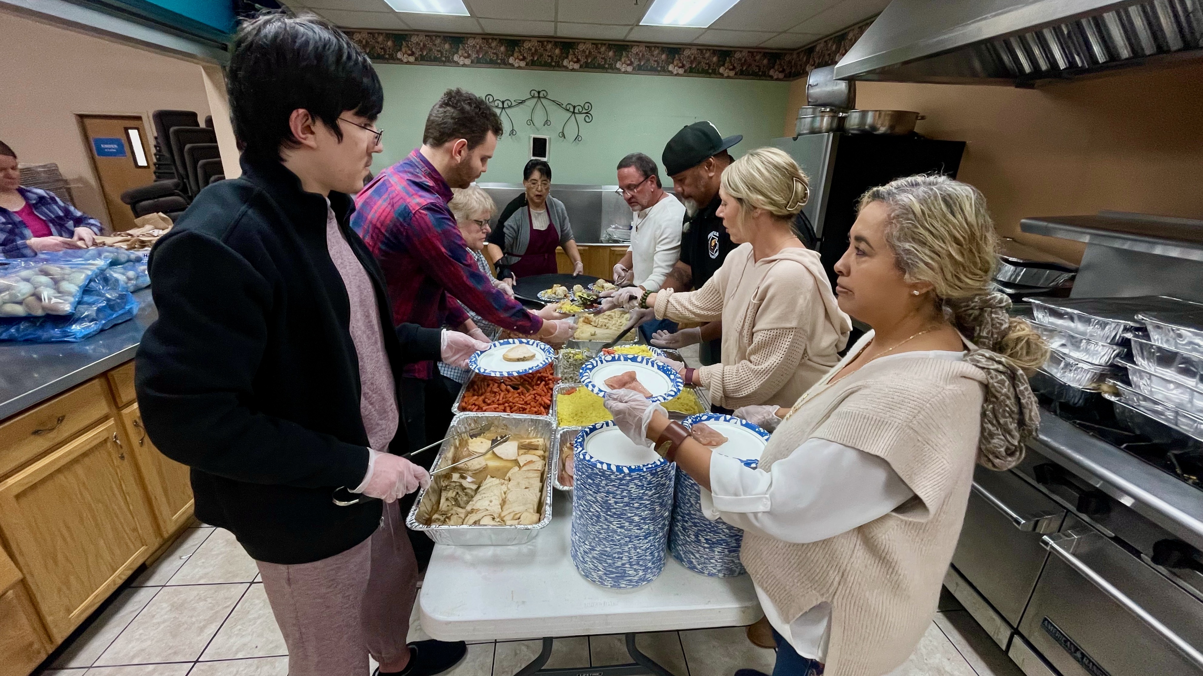 Volunteers prepare plates of food at a Thanksgiving banquet hosted by the Salt Lake City Mission at VIVA Church in Salt Lake City on Thursday.