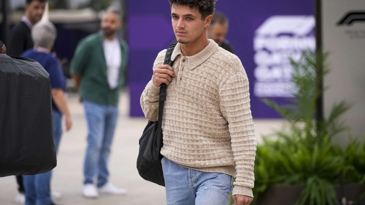 McLaren driver Lando Norris of Britain walks through paddock as he arrives at the Lusail International Circuit in Lusail, Qatar, ahead of the Qatar Grand Prix, Thursday, Nov. 28, 2024.