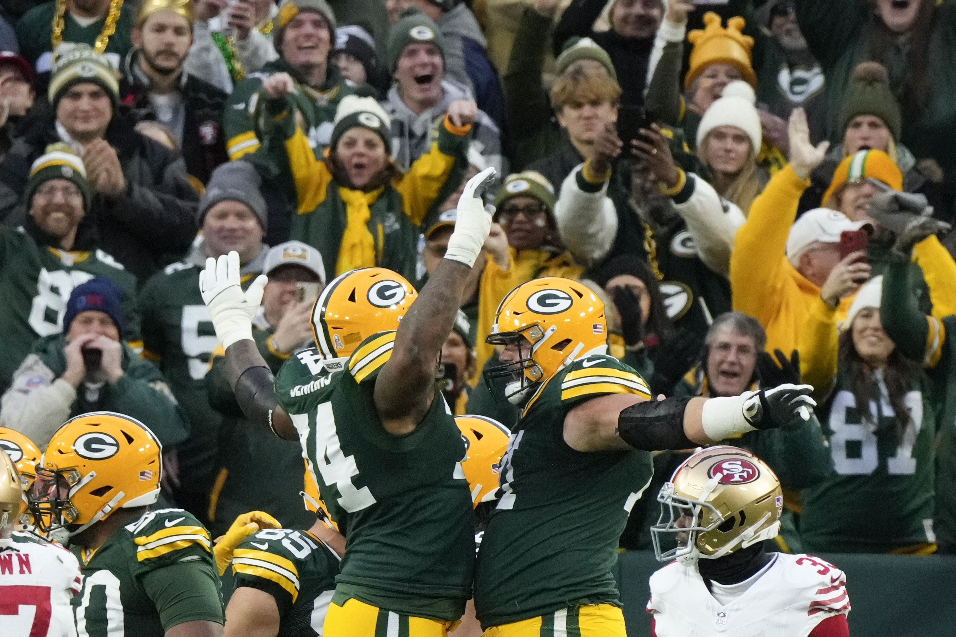 Green Bay Packers guard Elgton Jenkins, left, and Green Bay Packers center Josh Myers, right, celebrate a touchdown during the first half of an NFL football game against the San Francisco 49ers on Sunday, Nov. 24, 2024 in Green Bay, Wis. 