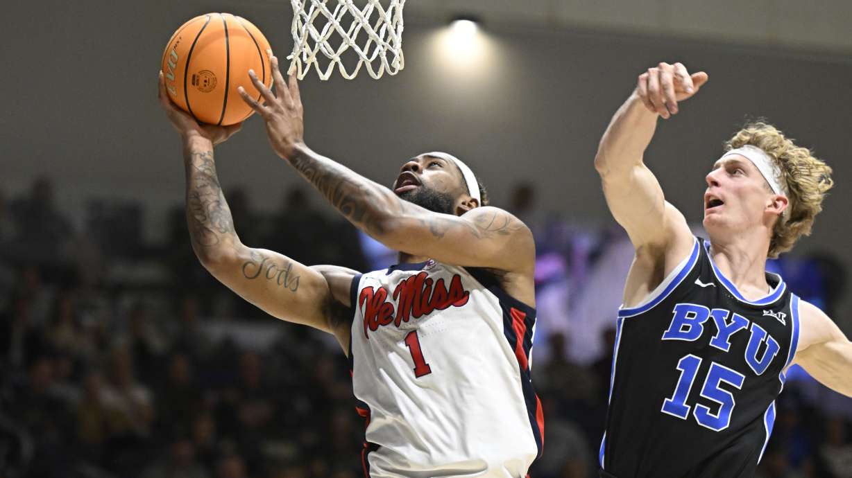 Mississippi forward Mikeal Brown-Jones (1) shoots past BYU forward Richie Saunders (15) during the first half of an NCAA college basketball game Thursday, Nov. 28, 2024, in San Diego.