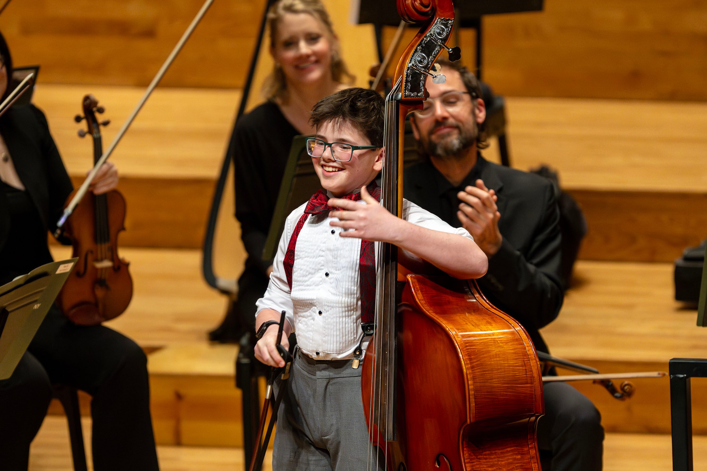 Aristotle Stokes (string bass) smiles as he finishes his piece during the Salute to Youth concert at Abravanel Hall, in Salt Lake City on Wednesday.