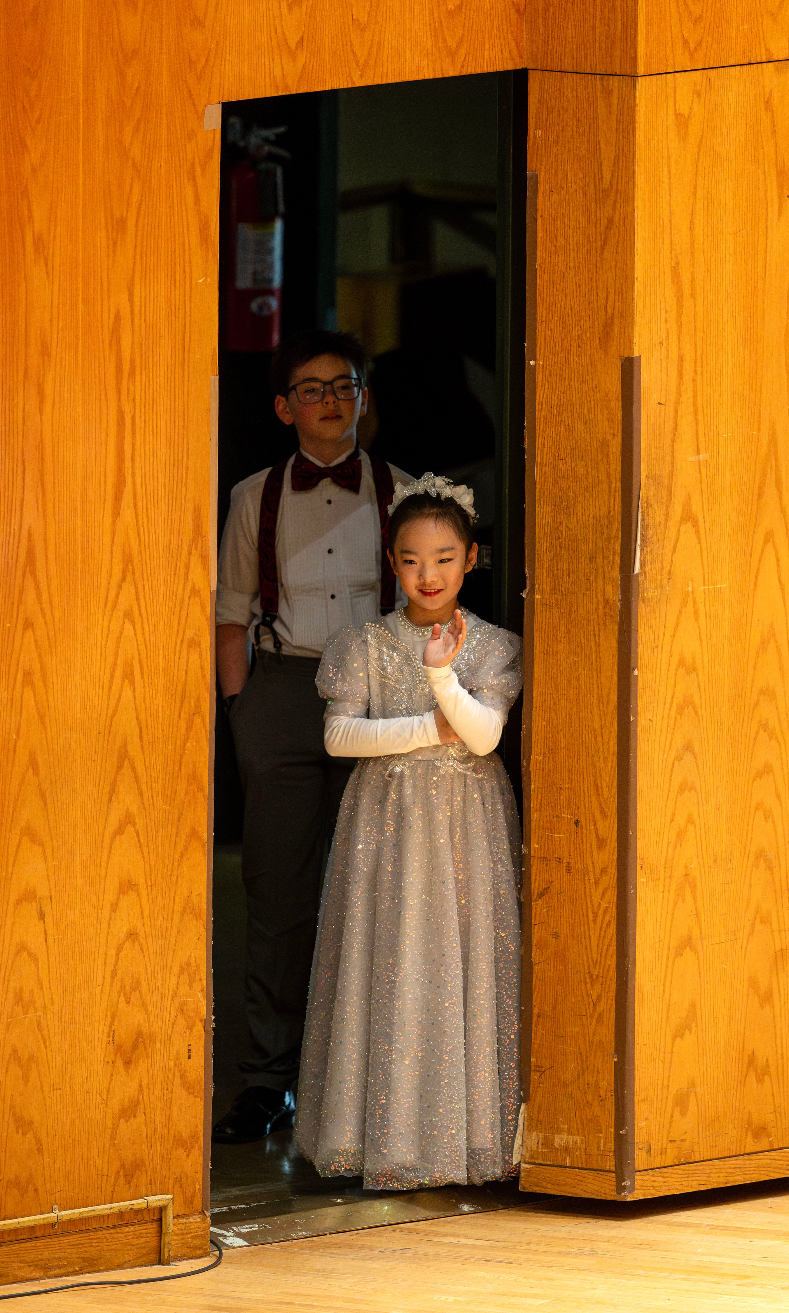 Natalie Sun and Aristotle Stokes look out at the audience during intermission of the Salute to Youth concert at Abravanel Hall in Salt Lake City on Wednesday.