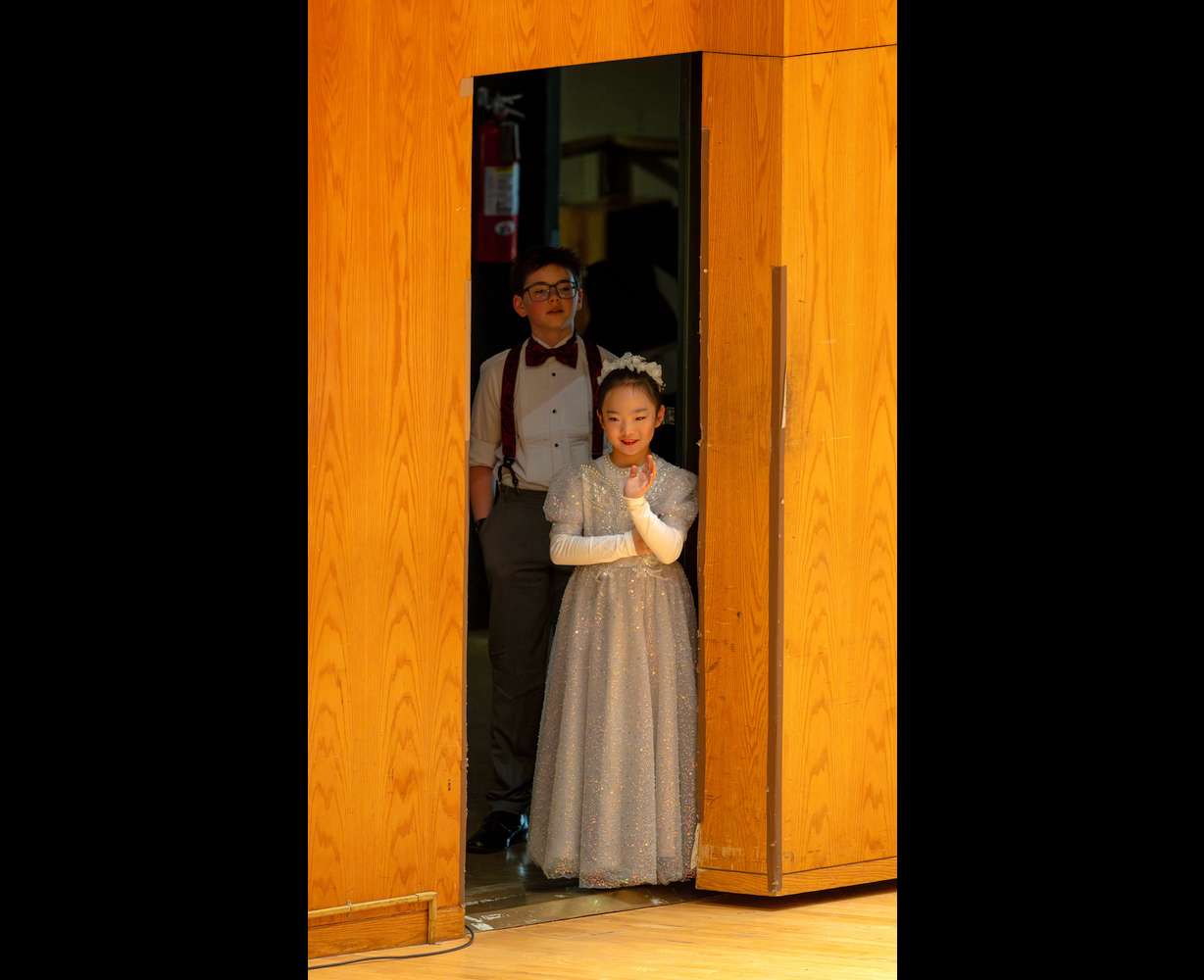 Natalie Sun and Aristotle Stokes look out at the audience during intermission of the Salute to Youth concert at Abravanel Hall in Salt Lake City on Wednesday.