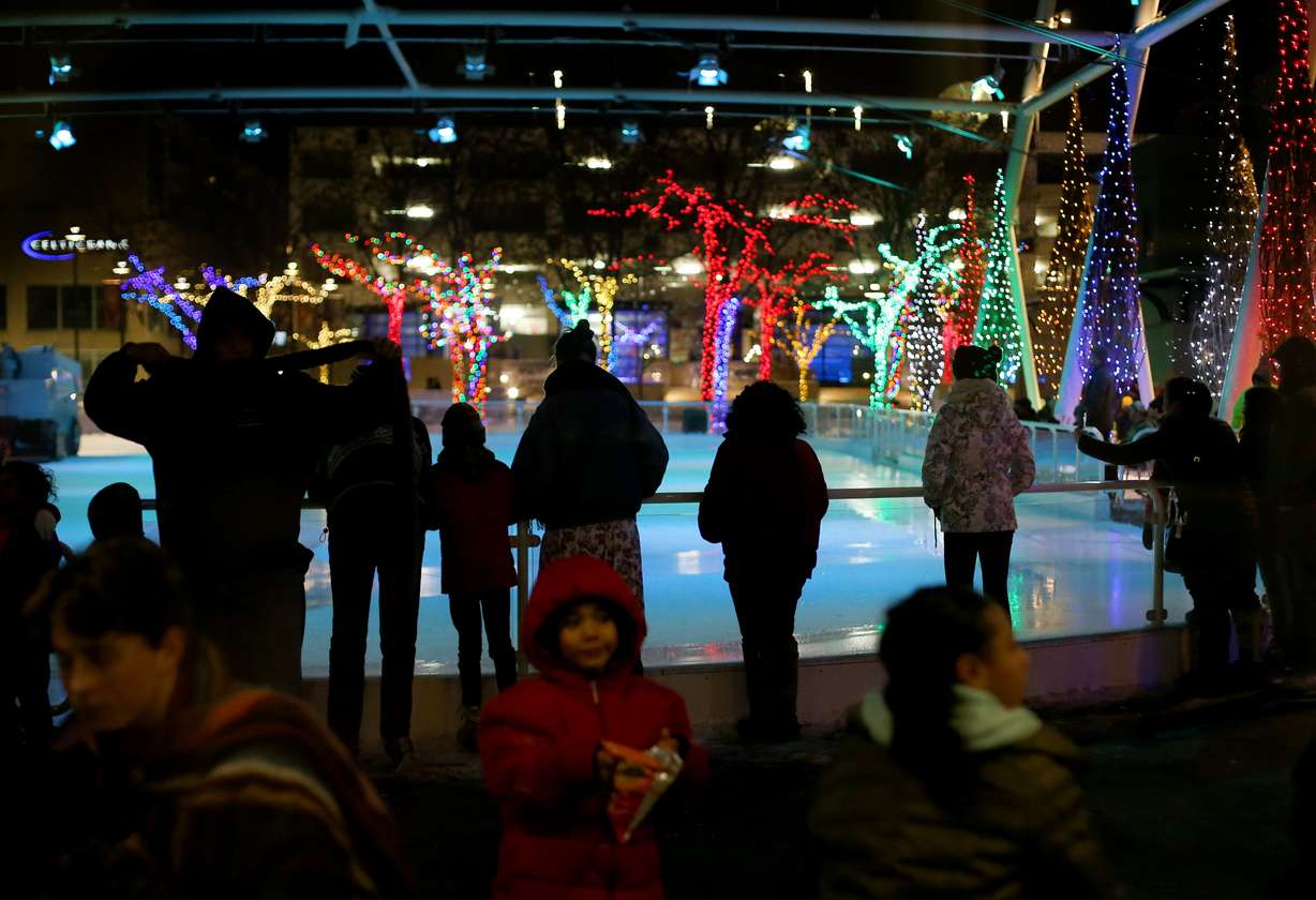 Skaters wait for the Zamboni to clean the ice at the Gallivan Center's ice skating rink in Salt Lake City on Dec. 28, 2018.