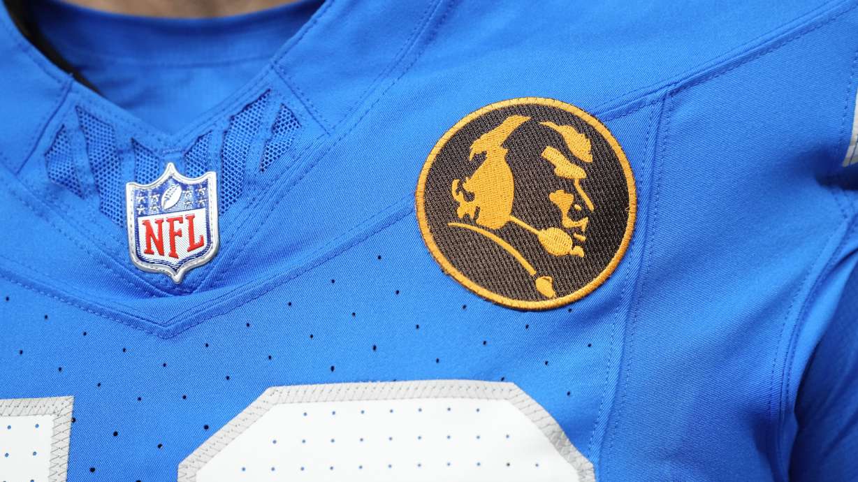 Detroit Lions long snapper Hogan Hatten (49) wears a John Madden patch on his jersey during an NFL football game against the Chicago Bears, Thursday, Nov. 28, 2024, in Detroit.
