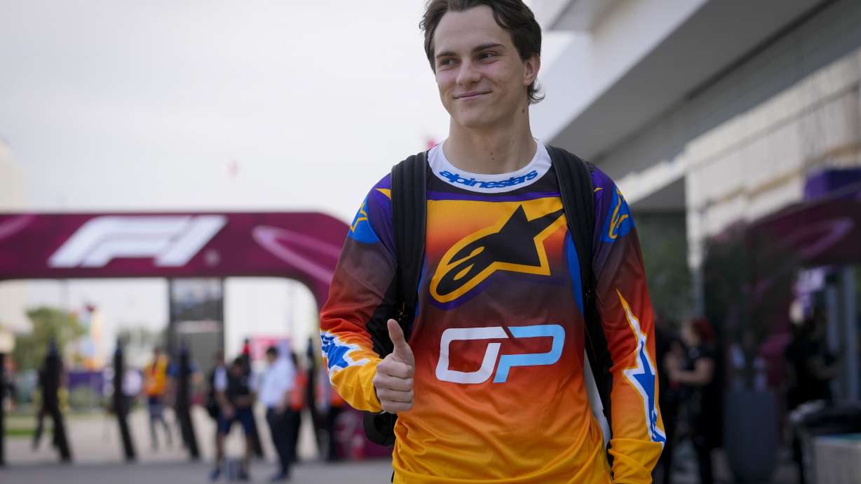 McLaren driver Oscar Piastri of Australia walks through paddock as he arrives at the Lusail International Circuit in Lusail, Qatar, ahead of the Qatar Grand Prix, Thursday, Nov. 28, 2024.