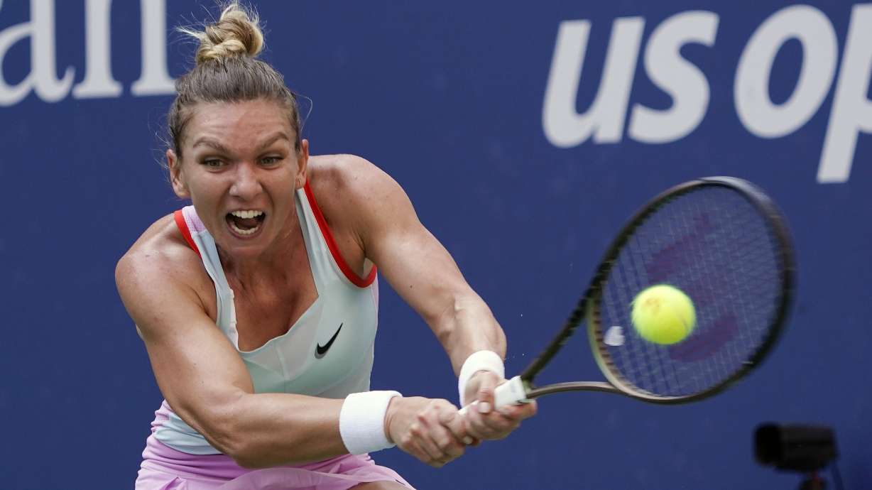 FILE - Simona Halep, of Romania, returns a shot to Daria Snigur, of Ukraine, during the first round of the U.S. Open tennis championships Aug. 29, 2022, in New York.