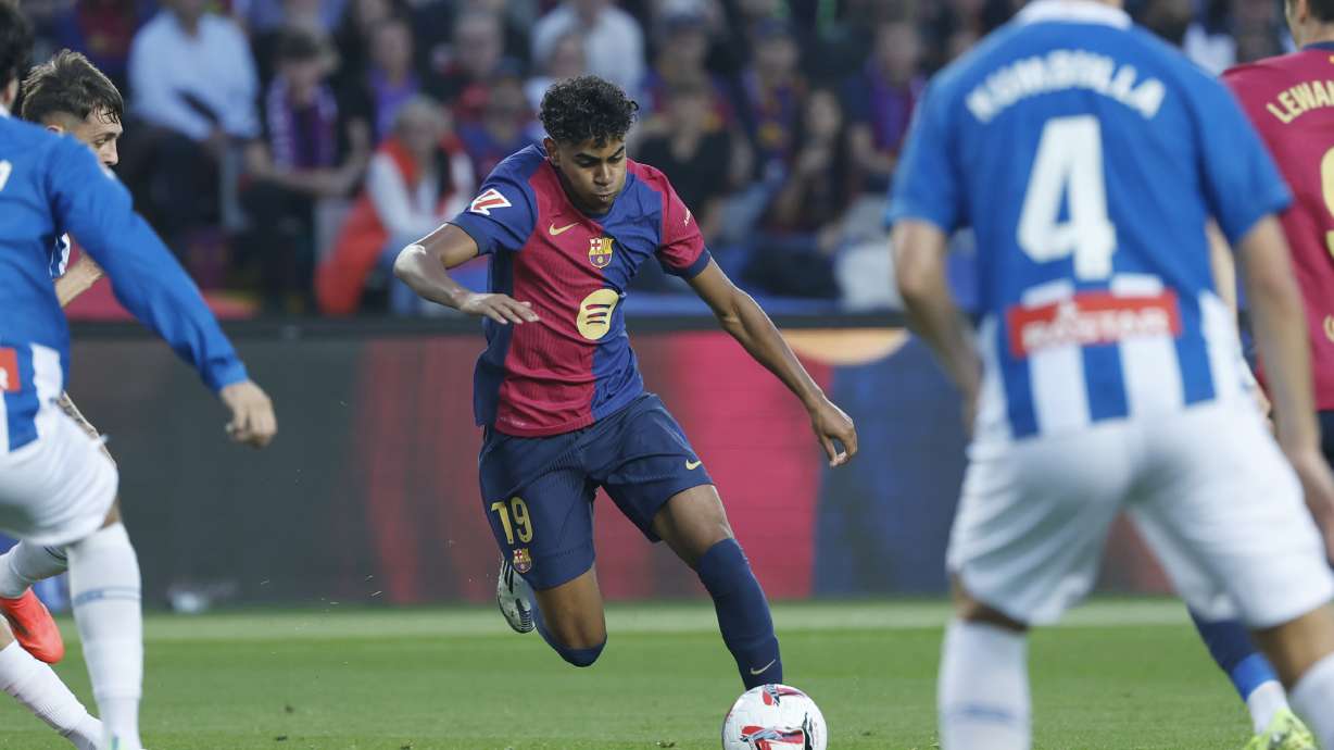 Barcelona's Lamine Yamal, centre, in action during a Spanish La Liga soccer match between Barcelona and Espanyol at the Lluis Companys Olympic Stadium in Barcelona, Spain, Sunday, Nov. 3, 2024.
