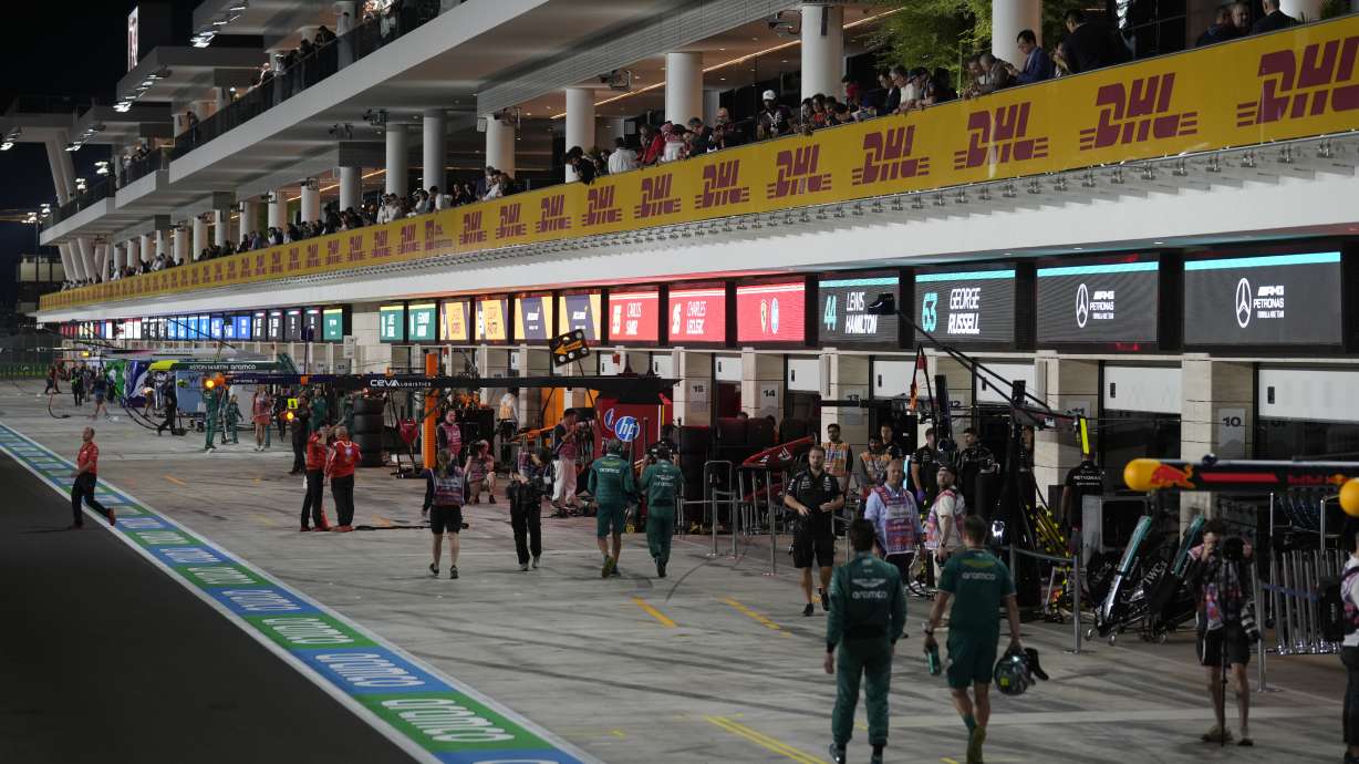 Temas crews walk along the paddock after practice at the Lusail International Circuit in Lusail, Qatar, ahead of the Qatar Formula One Grand Prix, Friday, Nov. 29, 2024.