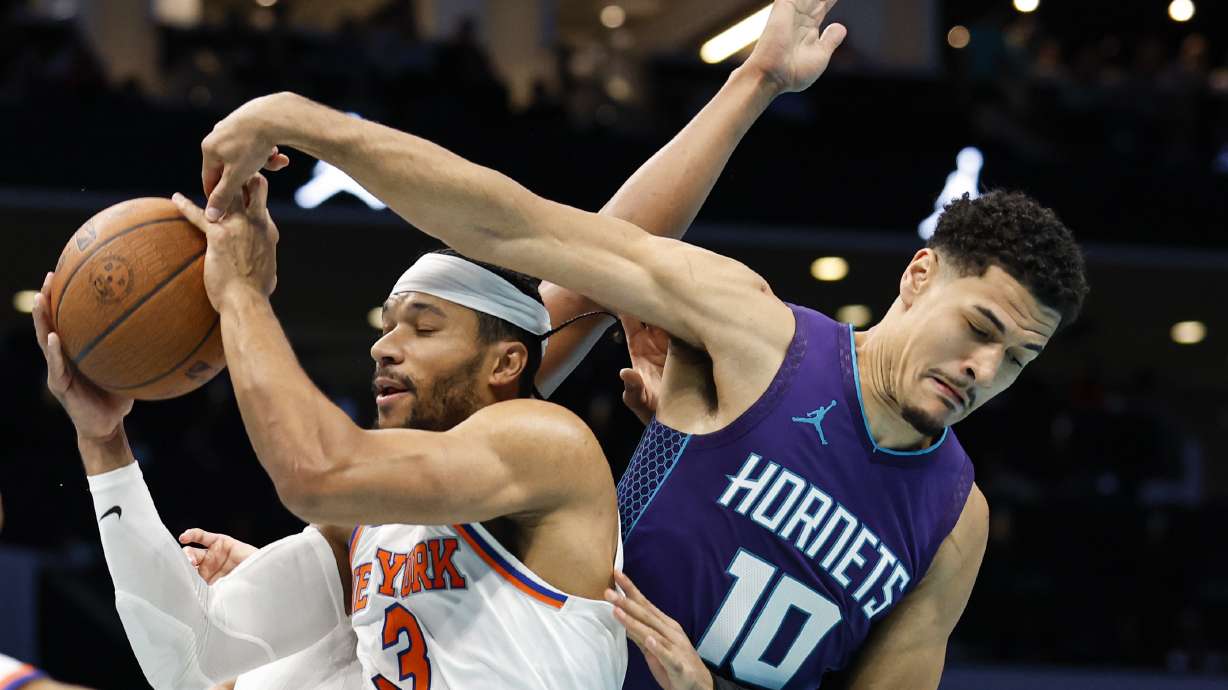 New York Knicks guard Josh Hart (3) rebounds against Charlotte Hornets guard Josh Green (10) during the first half of an Emirates NBA Cup basketball game in Charlotte, N.C., Friday, Nov. 29, 2024.