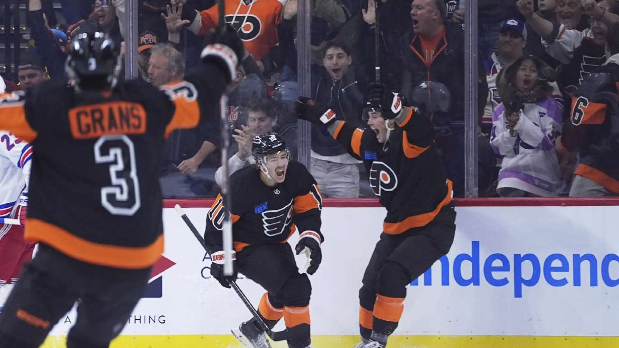Philadelphia Flyers' Bobby Brink, center, celebrates with Tyson Foerster, right, and Helge Grans after scoring a goal during the first period of an NHL hockey game against the New York Rangers, Friday, Nov. 29, 2024, in Philadelphia.