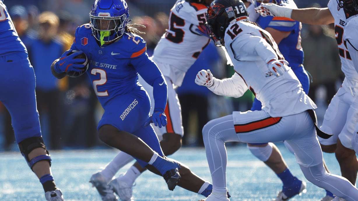 Boise State running back Ashton Jeanty (2) cuts away from Oregon State defensive back Tyrice Ivy Jr. (12) on a run in the first half of an NCAA college football game, Friday, Nov. 29, 2024, in Boise, Idaho.