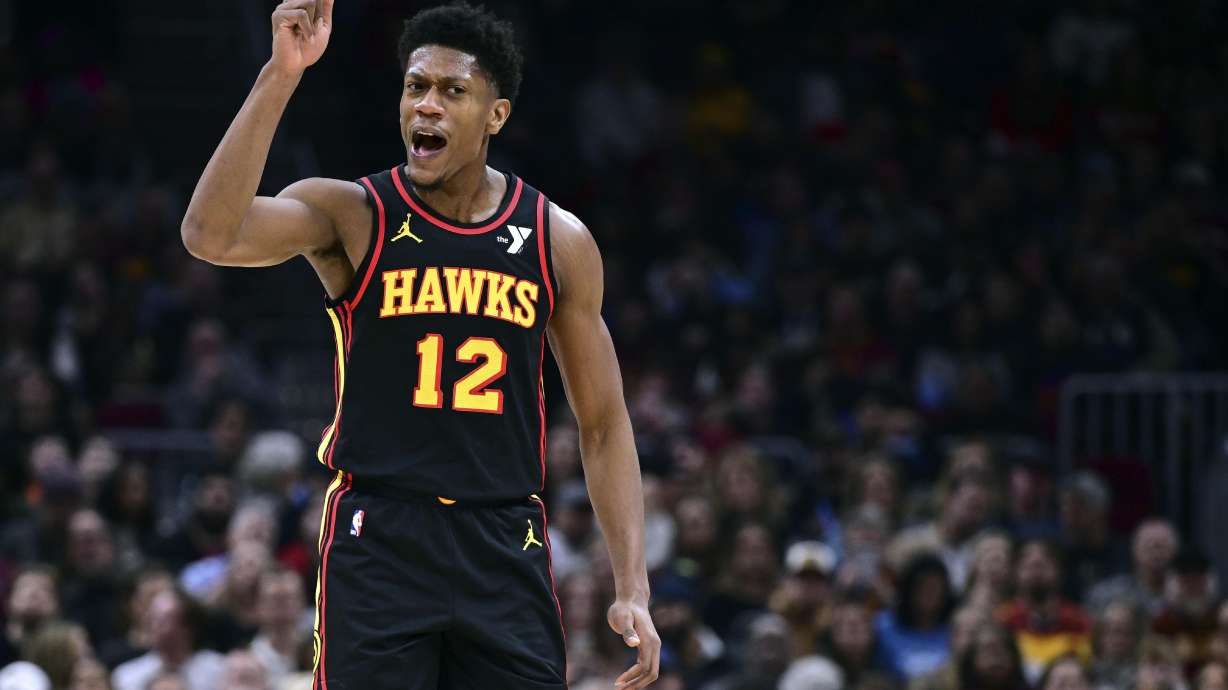 Atlanta Hawks forward De'Andre Hunter reacts after making a basket in the first half of an NBA basketball game against the Cleveland Cavaliers, Wednesday, Nov. 27, 2024, in Cleveland.