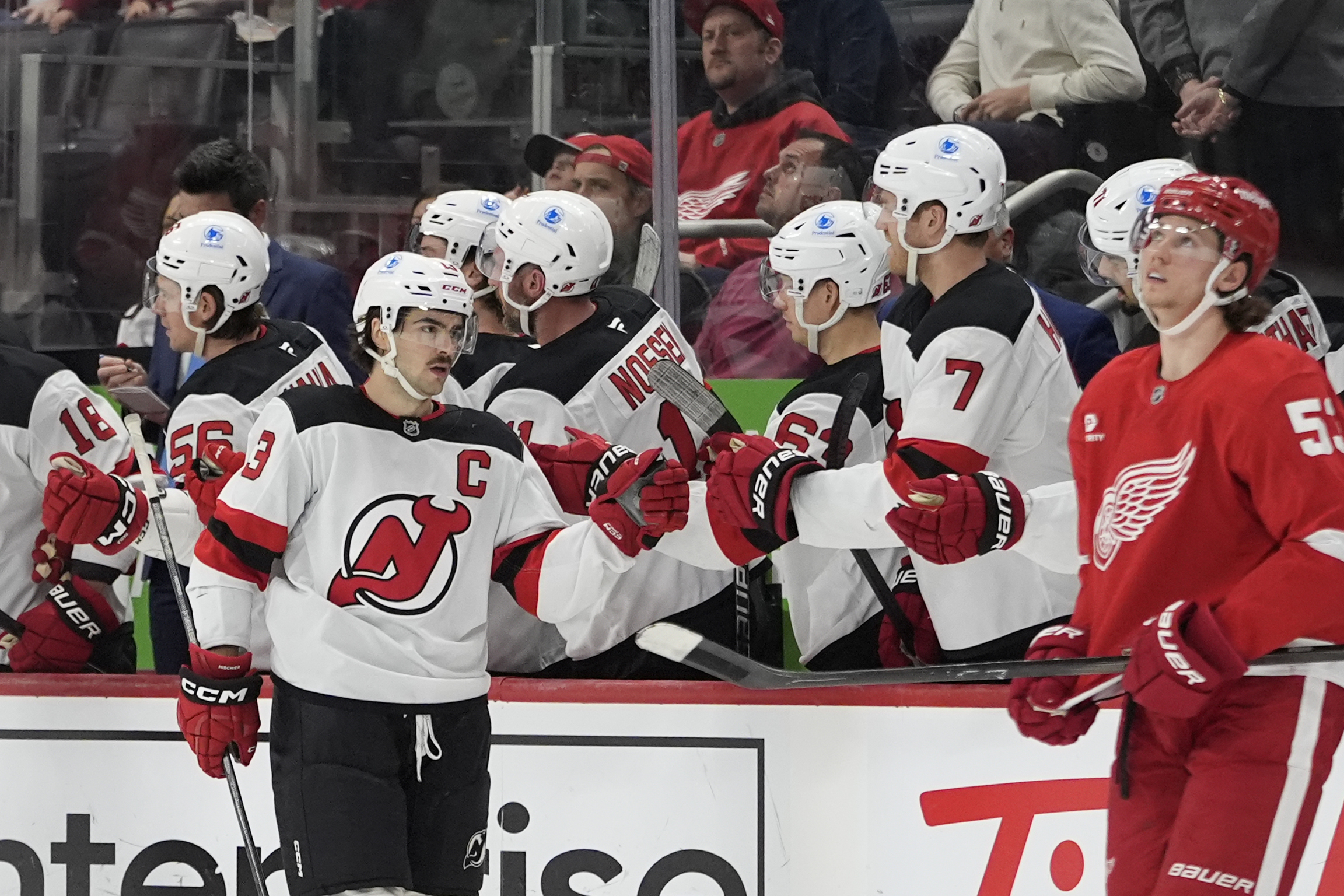 New Jersey Devils center Nico Hischier greets teammates after scoring during the second period of an NHL hockey game against the Detroit Red Wings, Friday, Nov. 29, 2024, in Detroit.