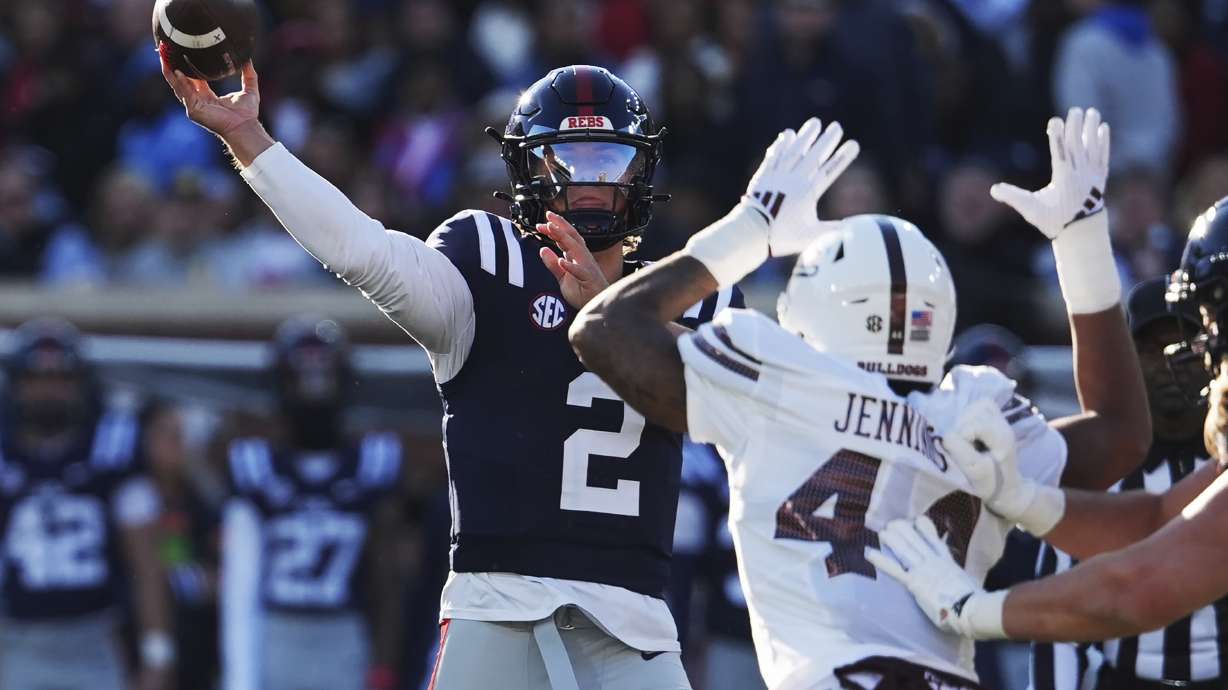 Mississippi quarterback Jaxson Dart (2) passes while being pressured by Mississippi State linebacker Branden Jennings (44) during the first half of an NCAA college football game, Friday, Nov. 29, 2024, in Oxford, Miss.