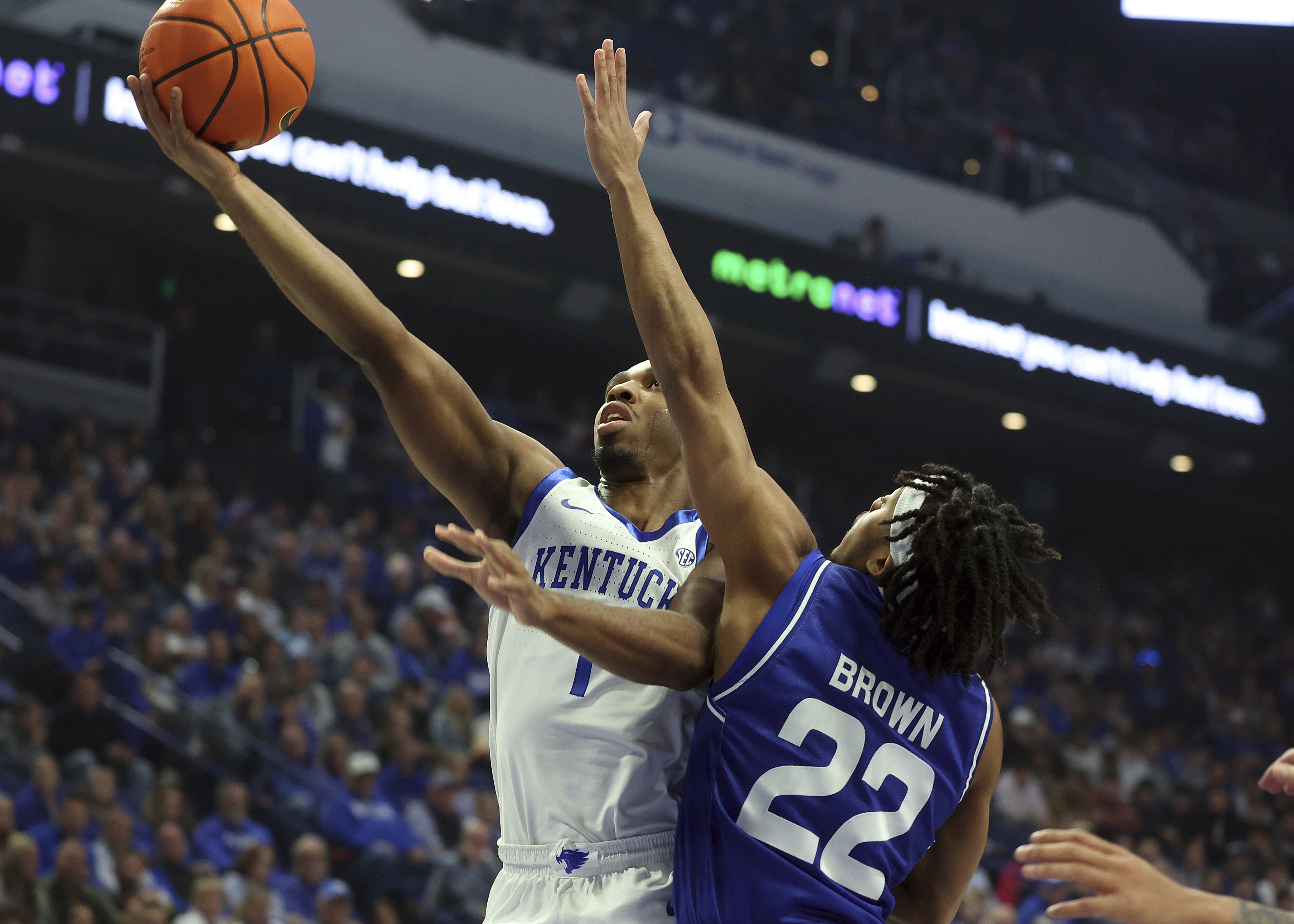 Kentucky's Lamont Butler, left, shoots while pressured by Georgia State's Malachi Brown (22) during the first half of an NCAA college basketball game in Lexington, Ky., Friday, Nov. 29, 2024. 
