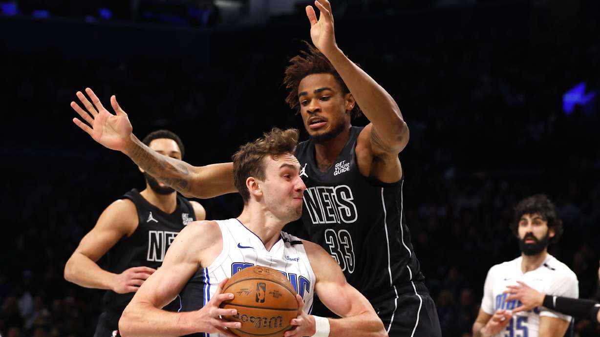 Orlando Magic forward Franz Wagner drives to the basket against Brooklyn Nets center Nic Claxton (33) during the first half of an Emirates NBA Cup basketball game, Friday, Nov. 29, 2024, in New York.
