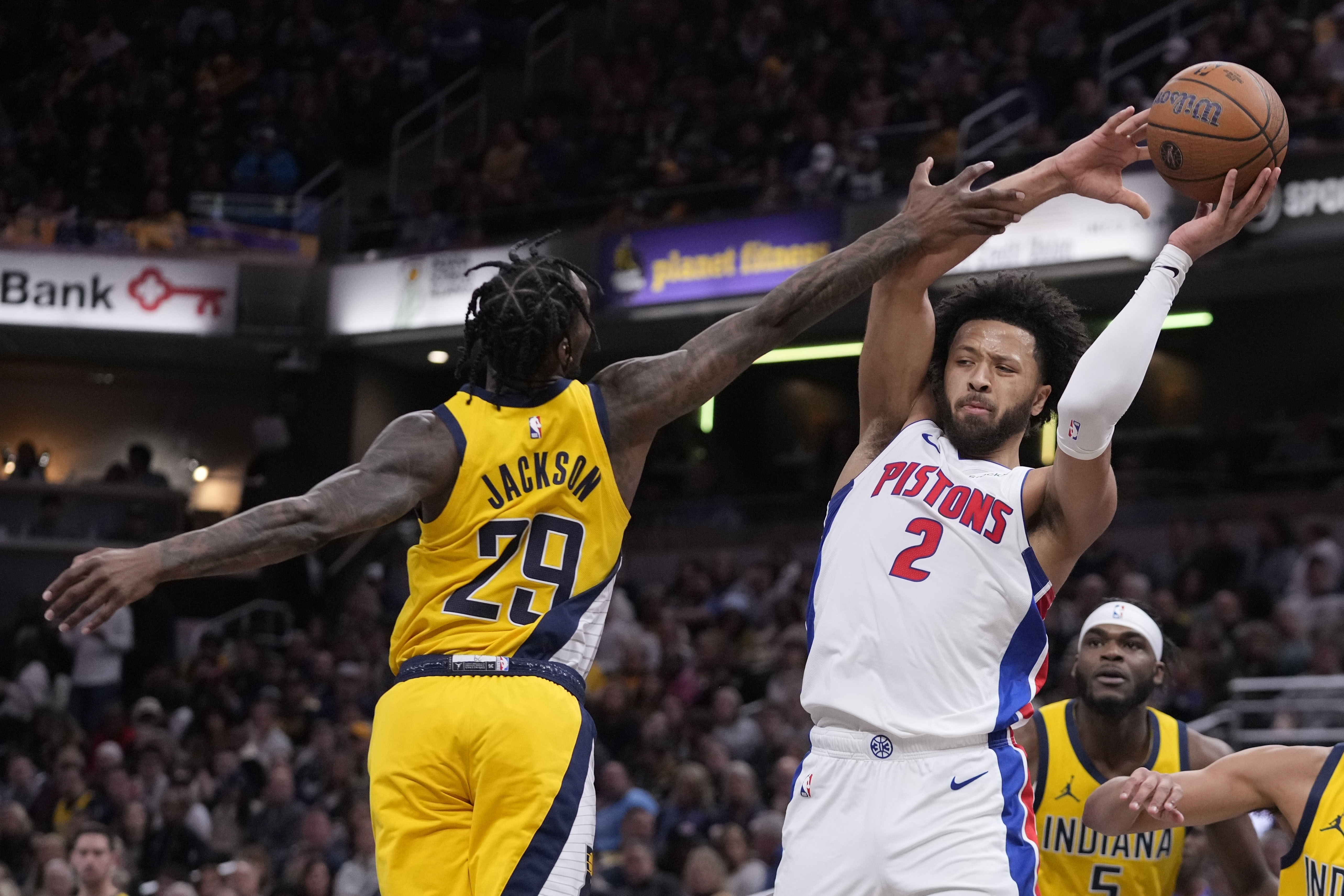 Detroit Pistons' Cade Cunningham (2) is fouled by Indiana Pacers' Quenton Jackson (29) during the first half of an Emirates NBA Cup basketball game, Friday, Nov. 29, 2024, in Indianapolis. 