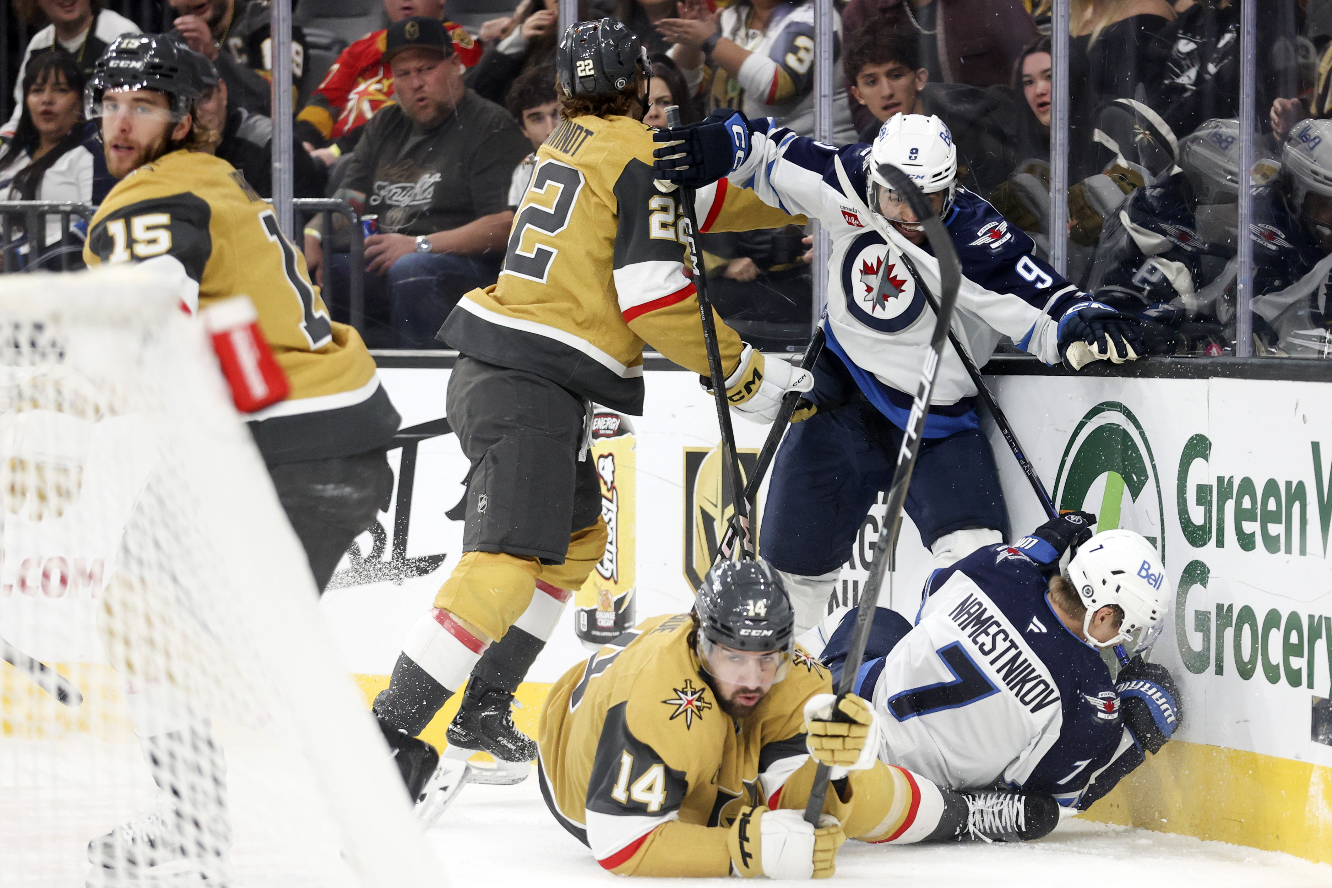 Vegas Golden Knights right wing Cole Schwindt (22) and defenseman Nicolas Hague (14) collide with Winnipeg Jets left wing Alex Iafallo (9) and center Vladislav Namestnikov (7) during the first period of an NHL hockey game Friday, Nov. 29, 2024, in Las Vegas. 