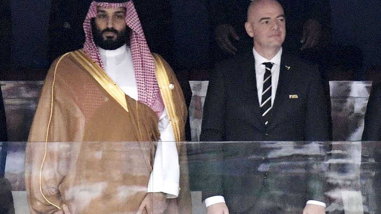FILE - Saudi Arabia Crown Prince Mohammed bin Salman, left, and FIFA President Gianni Infantino, stand for the anthem prior to the match between Russia and Saudi Arabia which opened the 2018 soccer World Cup at the Luzhniki stadium in Moscow, Russia, on June 14, 2018.