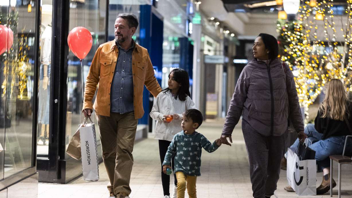 The Gray family looks into a shop window on their way out of City Creek Center after doing some Christmas shopping in Salt Lake City on Nov. 22.