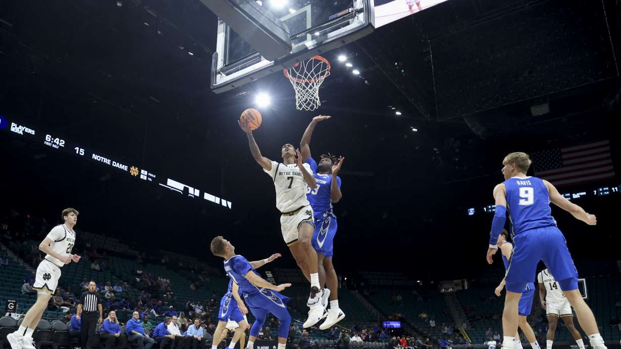 Notre Dame forward Tae Davis (7) shoots against Creighton guard Steven Ashworth (1) and center Fredrick King (33) during the first half of an NCAA college basketball game Saturday, Nov. 30, 2024, in Las Vegas.