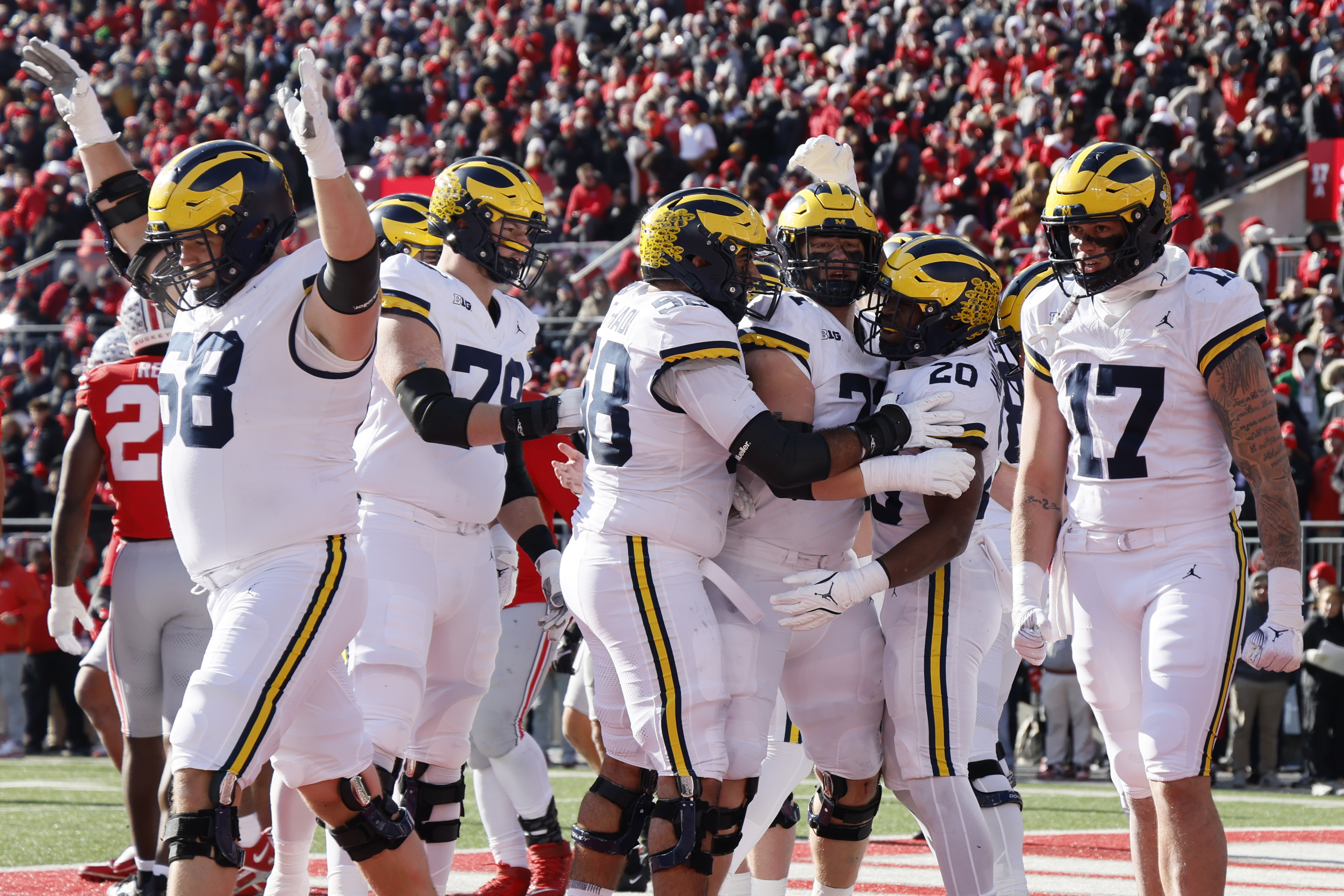 Michigan players celebrate their touchdown against Ohio State during the first half of an NCAA college football game Saturday, Nov. 30, 2024, in Columbus, Ohio.