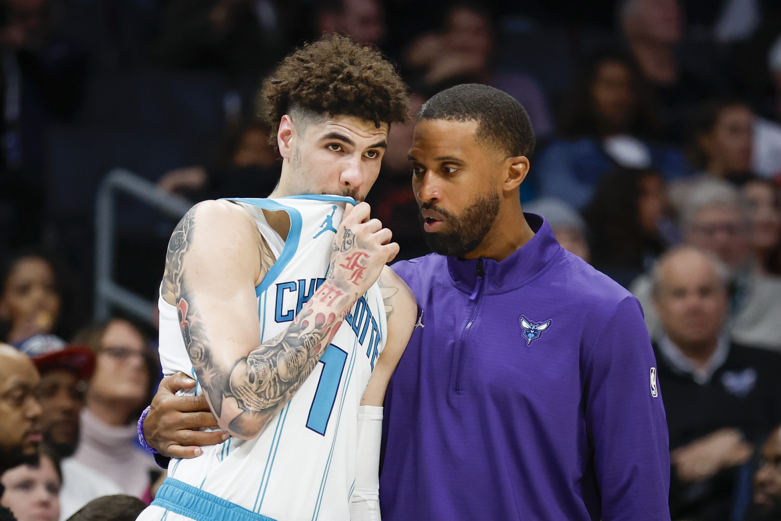 Charlotte Hornets head coach Charles Lee, right, talks to guard LaMelo Ball during the second half of an NBA basketball game against the Miami Heat in Charlotte, N.C., Wednesday, Nov. 27, 2024.