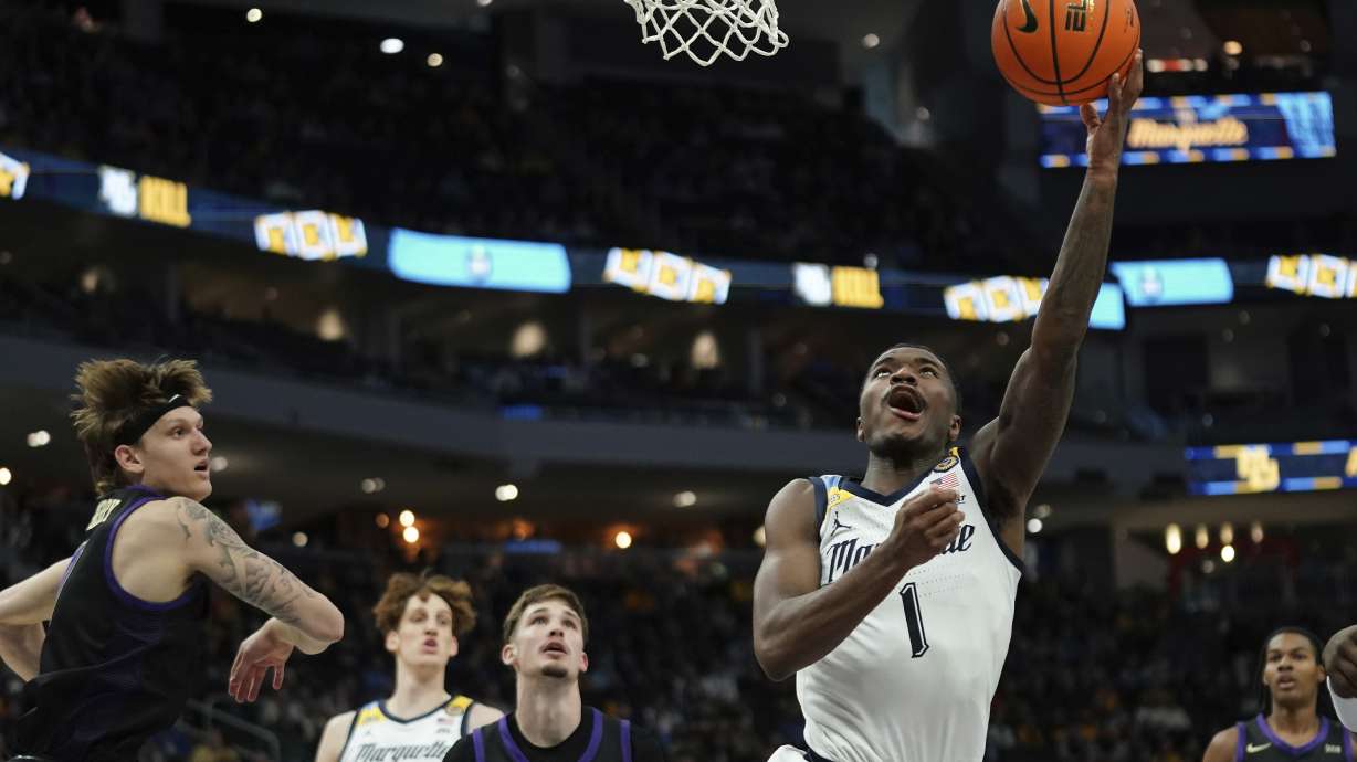 Marquette's Kam Jones (1) shoots a layup during the first half of an NCAA college basketball game against Western Carolina, Saturday, Nov. 30, 2024, in Milwaukee.