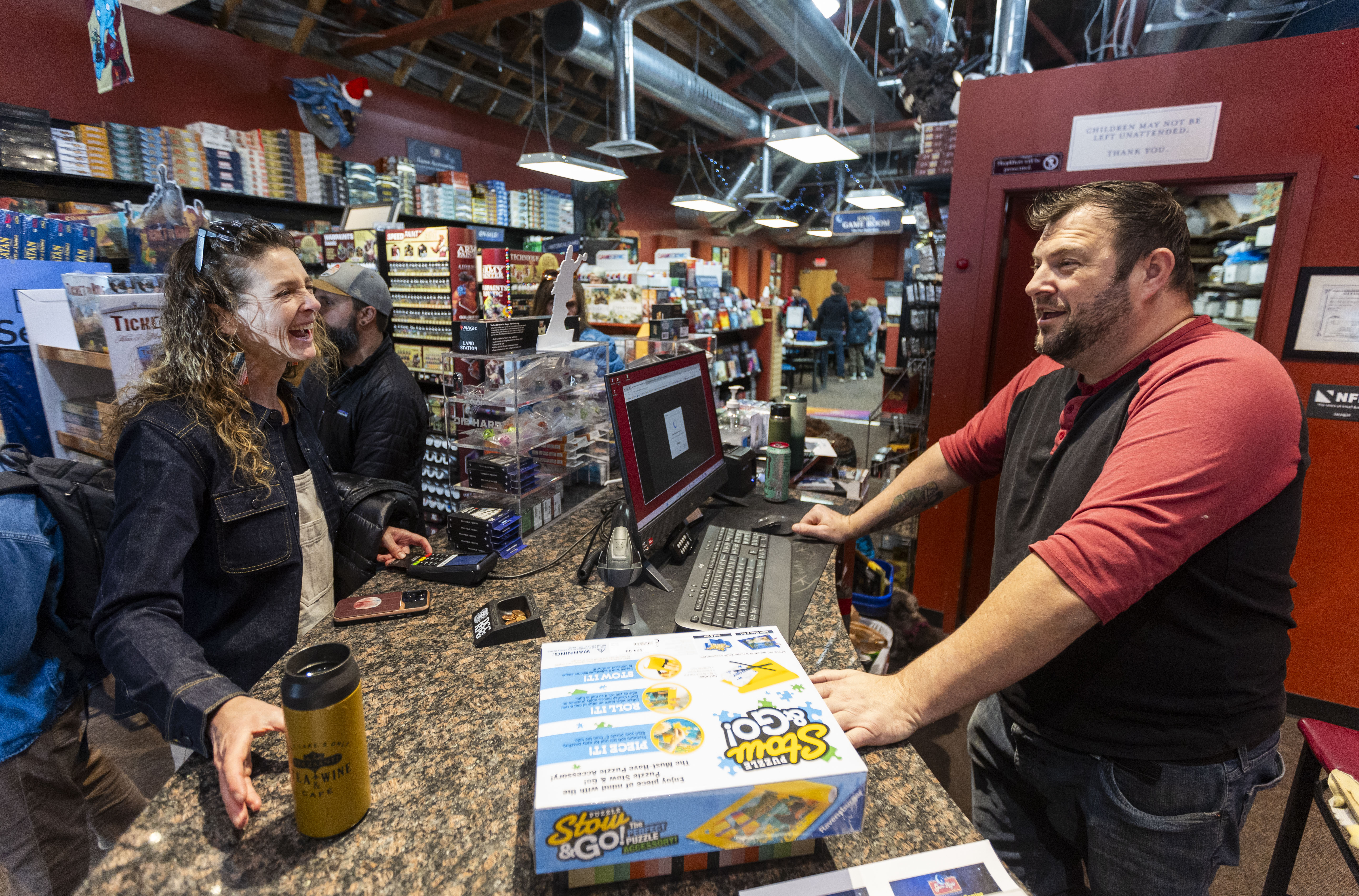 Becky Lyttle, from Salt Lake City, purchases games on Small Business Saturday at Game Night Games, a board and card game hobby store in the Sugar House neighborhood of Salt Lake City on Saturday.