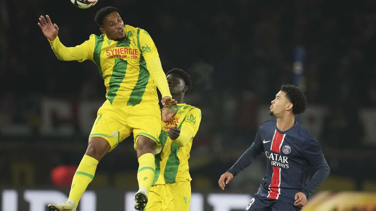 Nantes' Jean-Philippe Gbamin, left, heads the ball during the French League One soccer match between Paris Saint-Germain and Nantes at the Parc des Princes stadium in Paris, France, Saturday, Nov. 30, 2024.