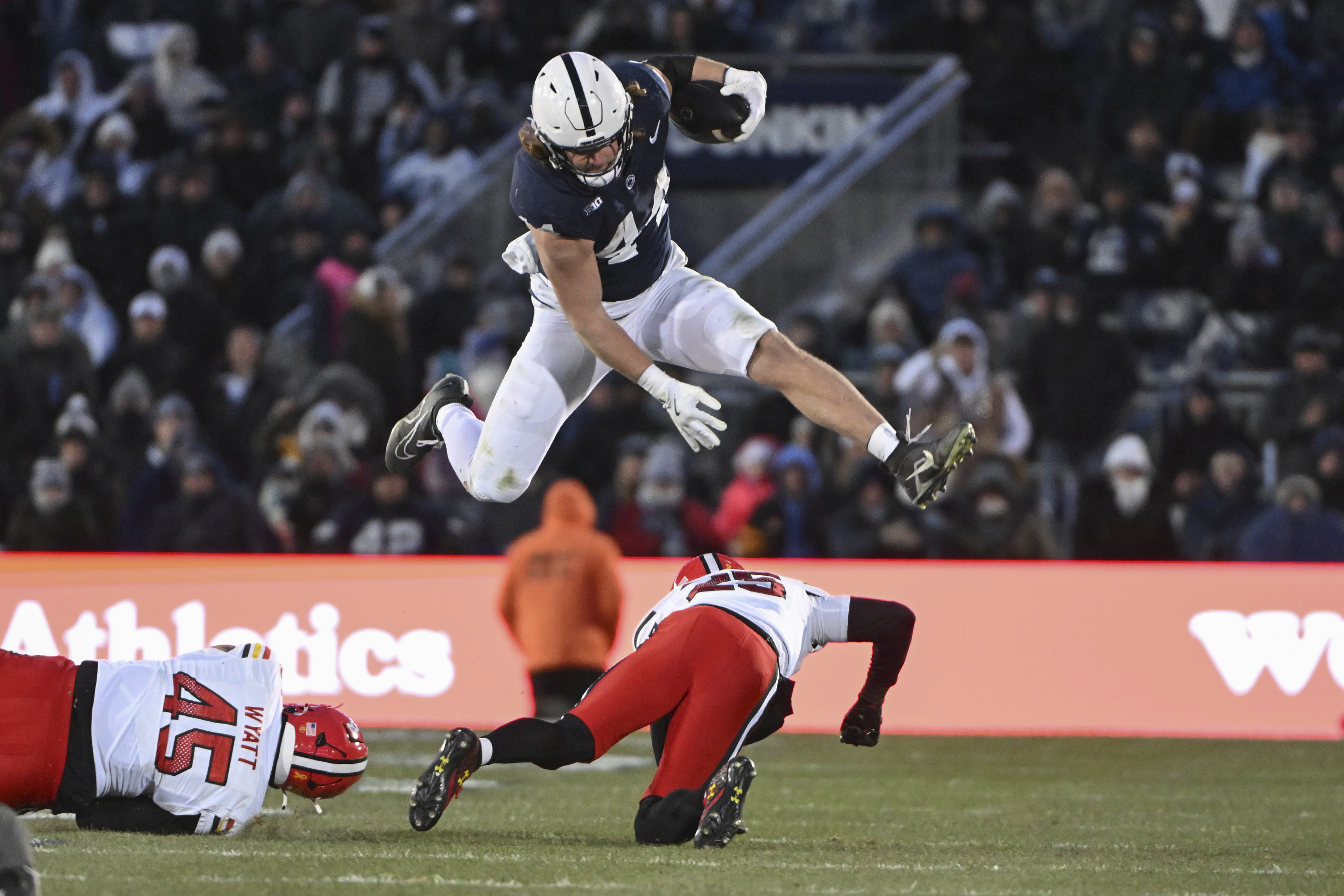 Penn State tight end Tyler Warren (44) hurdles Maryland defensive back Kevis Thomas (25) during the second quarter of an NCAA college football game, Saturday, Nov. 30, 2024, in State College, Pa. 