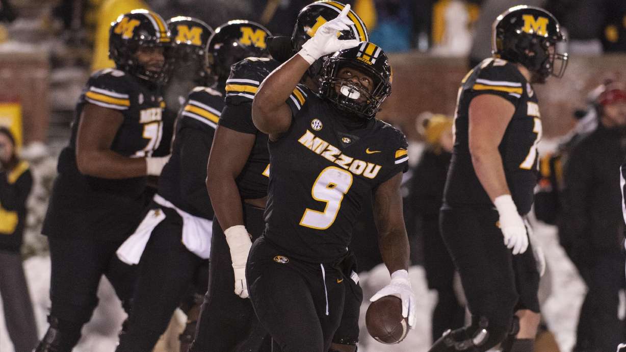 Missouri running back Marcus Carroll (9) celebrates after a touchdown during the second half of an NCAA college football game against Arkansas, Saturday, Nov. 30, 2024, in Columbia, Mo.