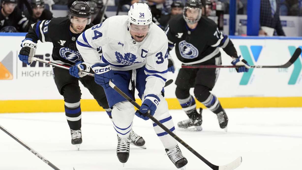 Toronto Maple Leafs center Auston Matthews (34) gets ahead of Tampa Bay Lightning left wing Brandon Hagel (38) and center Anthony Cirelli (71) during the first period of an NHL hockey game Saturday, Nov. 30, 2024, in Tampa, Fla.
