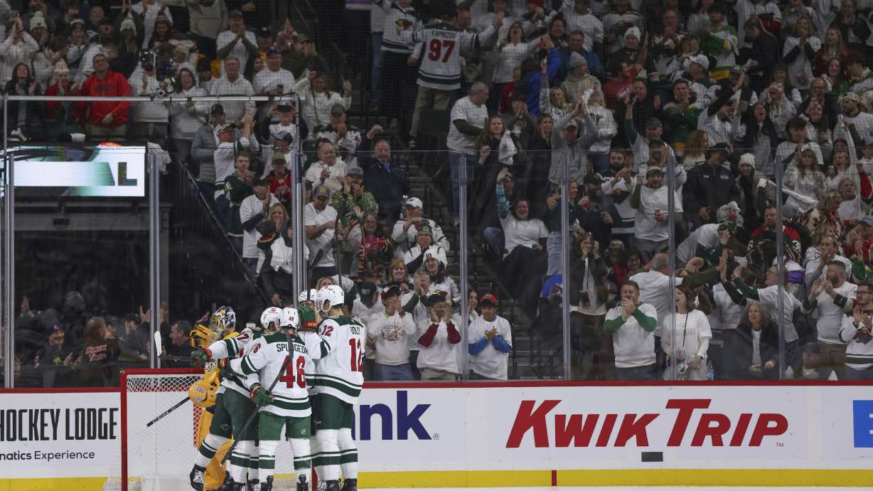 Minnesota Wild left wing Kirill Kaprizov celebrates with teammates after scoring a goal during the second period of an NHL hockey game against the Nashville Predators, Saturday, Nov. 30, 2024, in St. Paul, Minn.