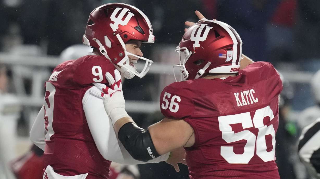 Indiana quarterback Kurtis Rourke (9) celebrates after throwing a touchdown pass with offensive lineman Mike Katic (56) during the first half of an NCAA college football game against Purdue, Saturday, Nov. 30, 2024, in Bloomington, Ind.