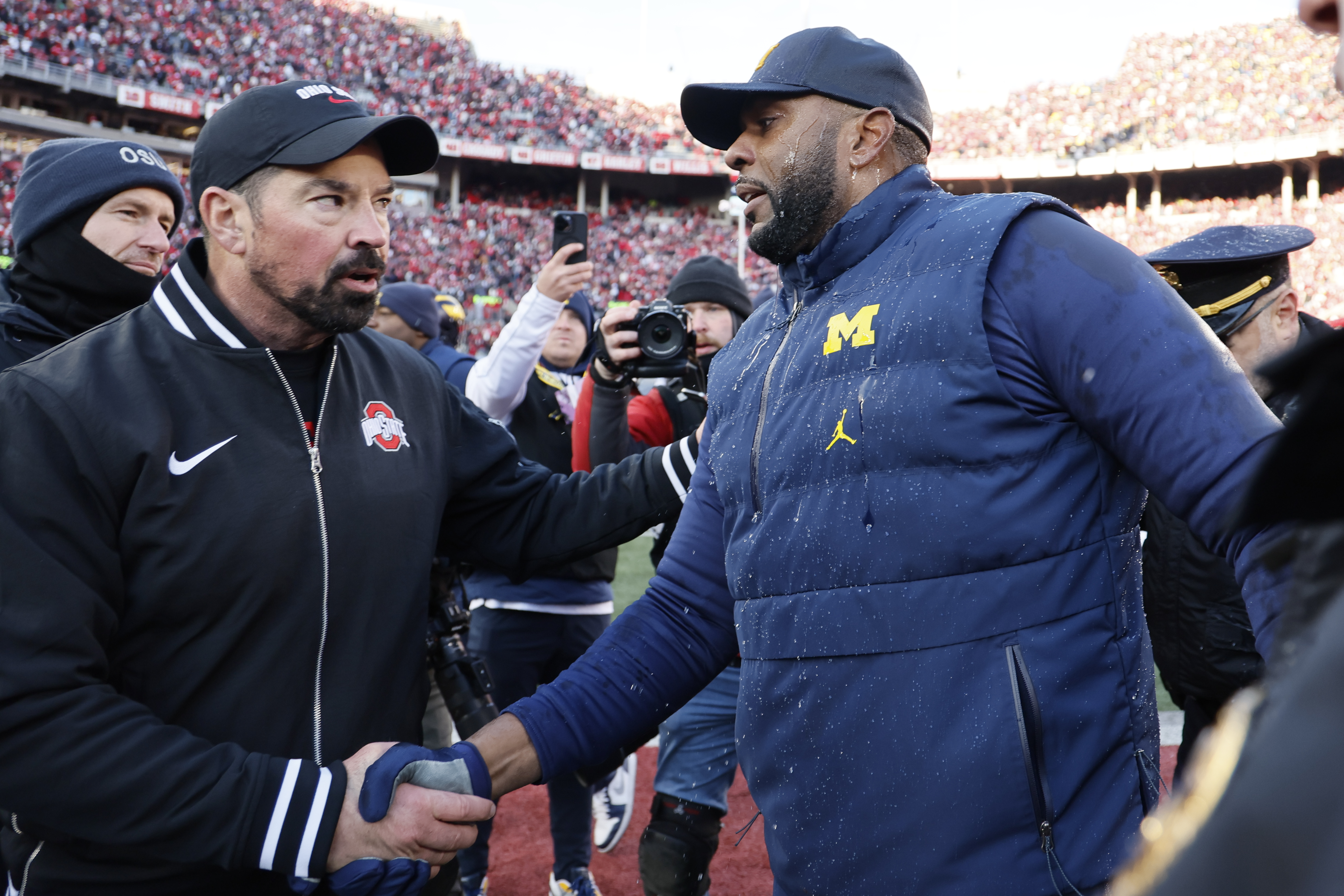 Ohio State head coach Ryan Day, left, and Michigan head coach Sherrone Moore shake hands after an NCAA college football game Saturday, Nov. 30, 2024, in Columbus, Ohio. 