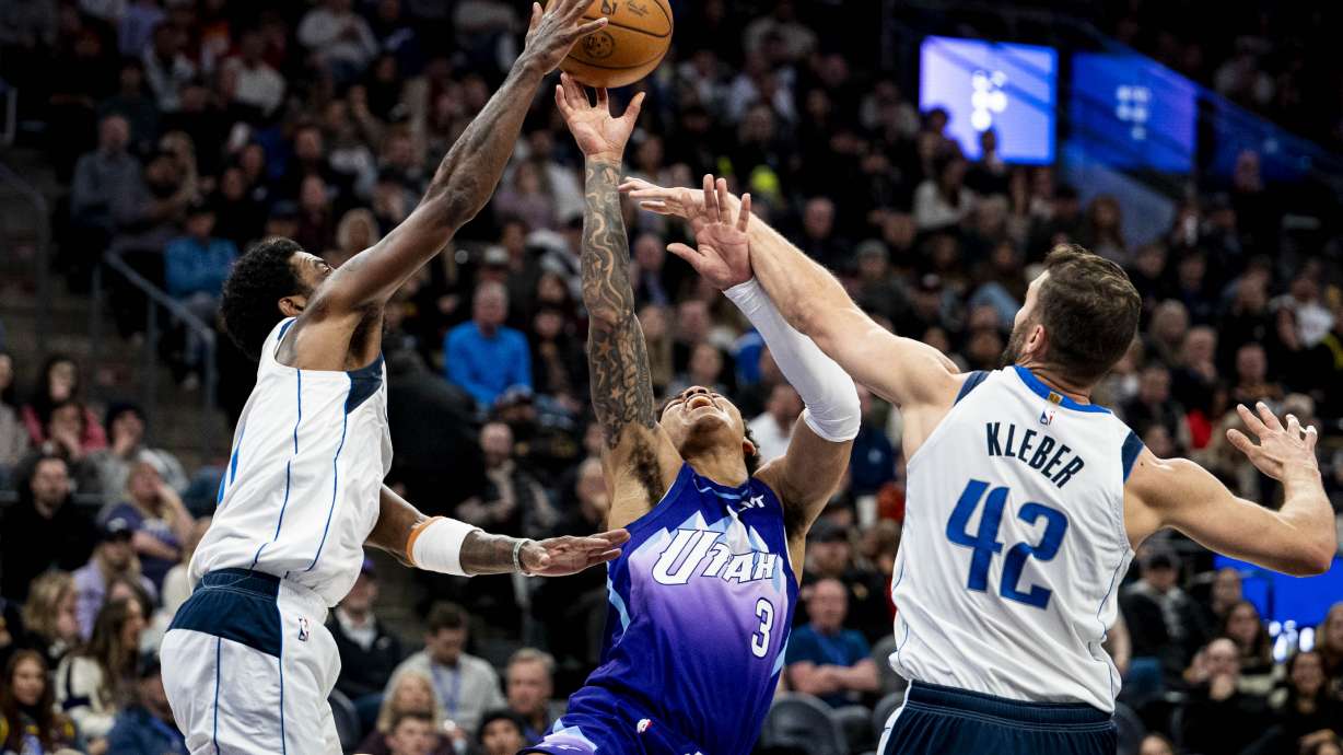 Utah Jazz guard Keyonte George (3) is fouled by Dallas Mavericks forward Maxi Kleber (42) and his shot is blocked by guard Kyrie Irving (11) during an NBA basketball game held at the Delta Center in Salt Lake City on Monday, Jan. 30, 2024.